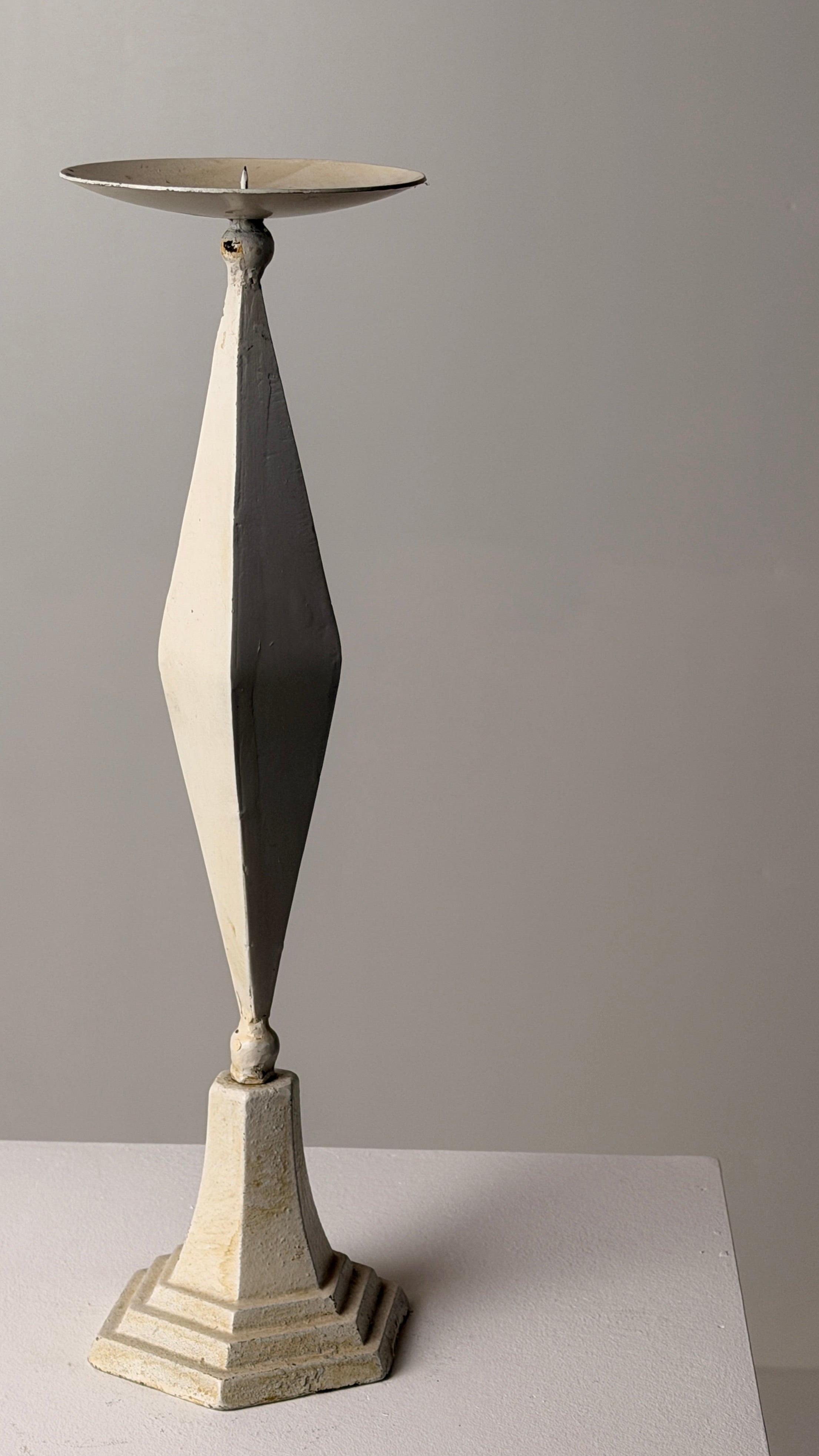 White-patinated Iron Candlestick, France, early 20th century — side angle on neutral background