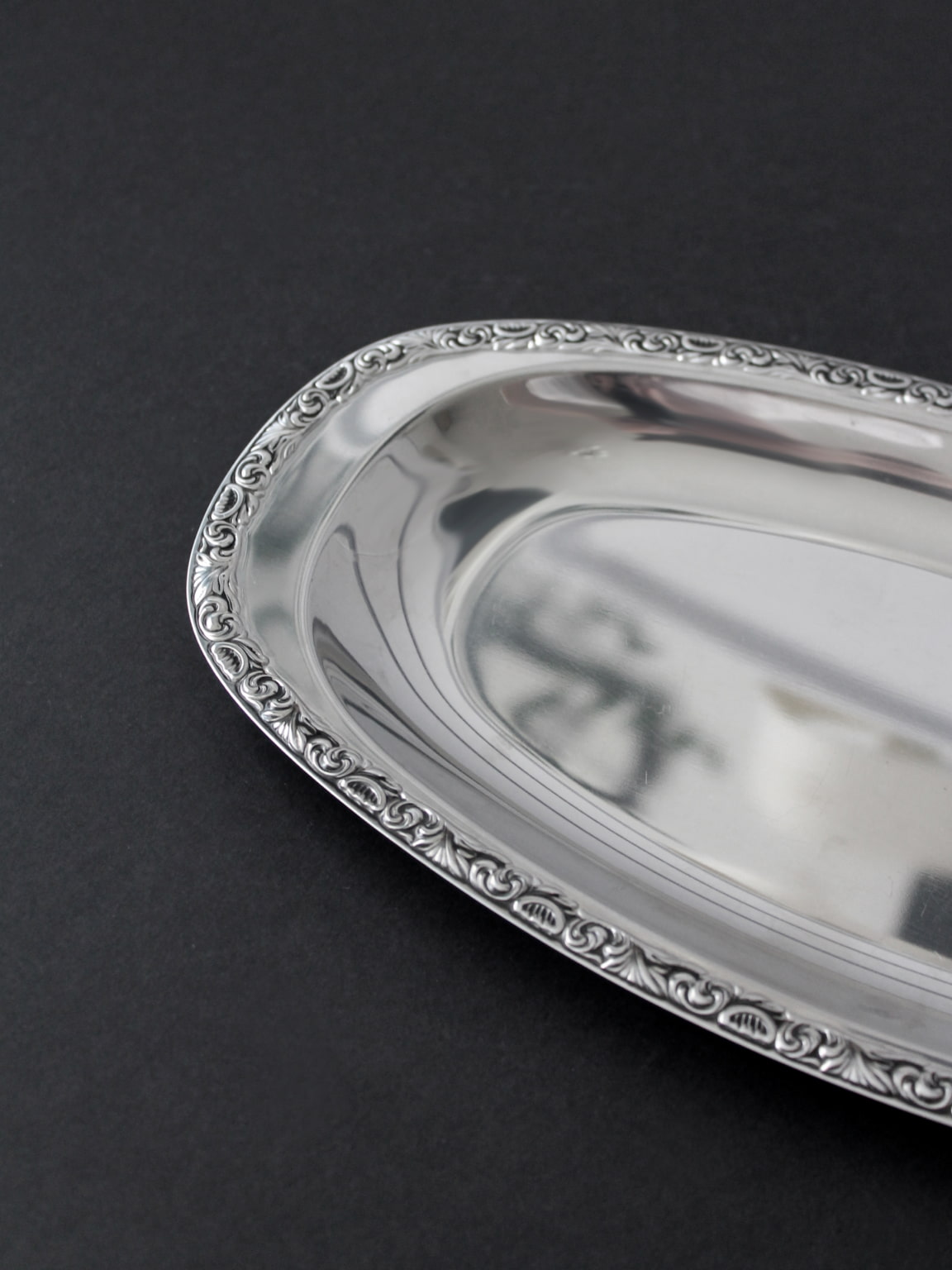 WMF "Baroque" Stainless Steel Tray And Coasters Set — angled view of polished tray edge