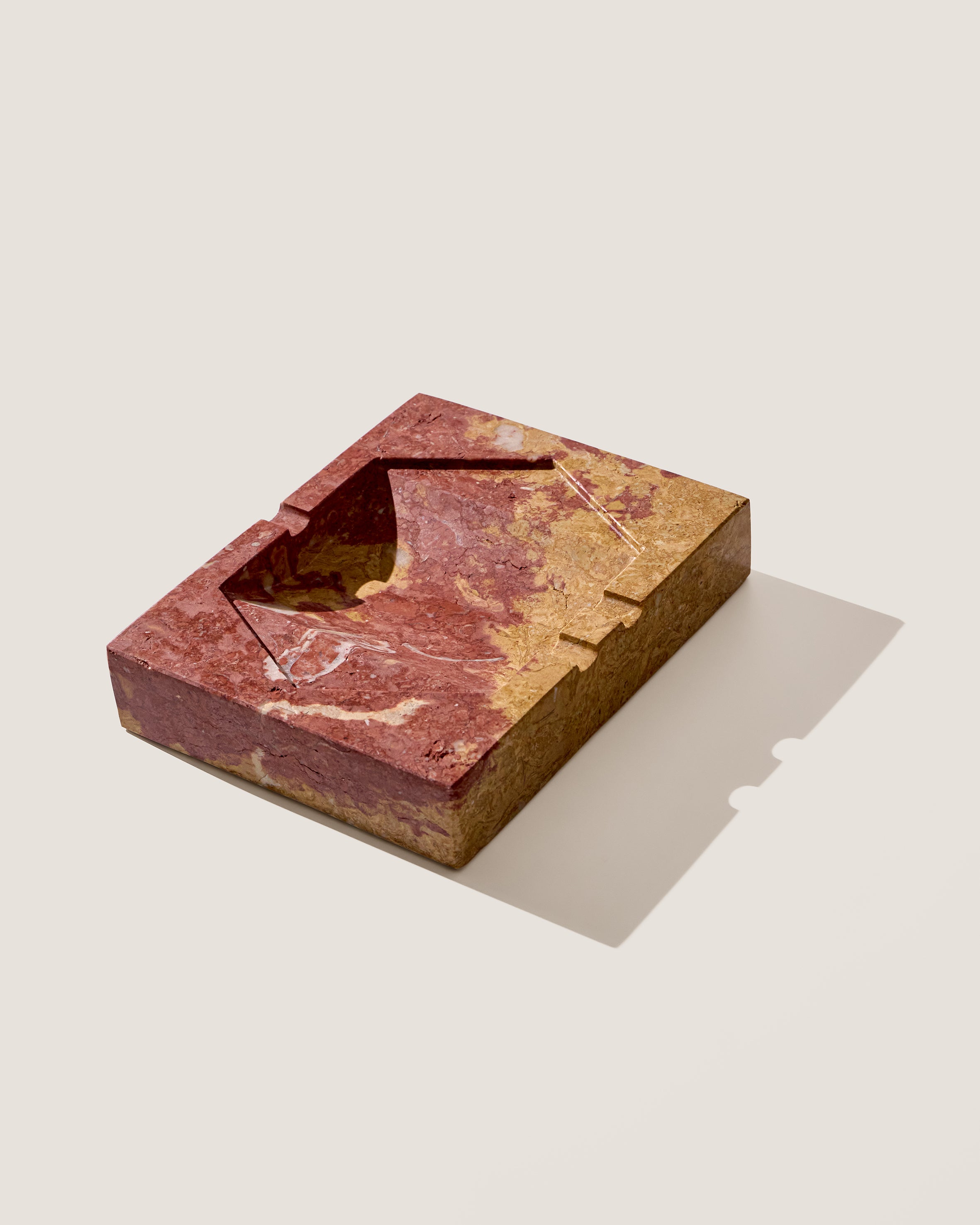 Ame IV Marble Ashtray — angled view highlighting red and gold marble texture