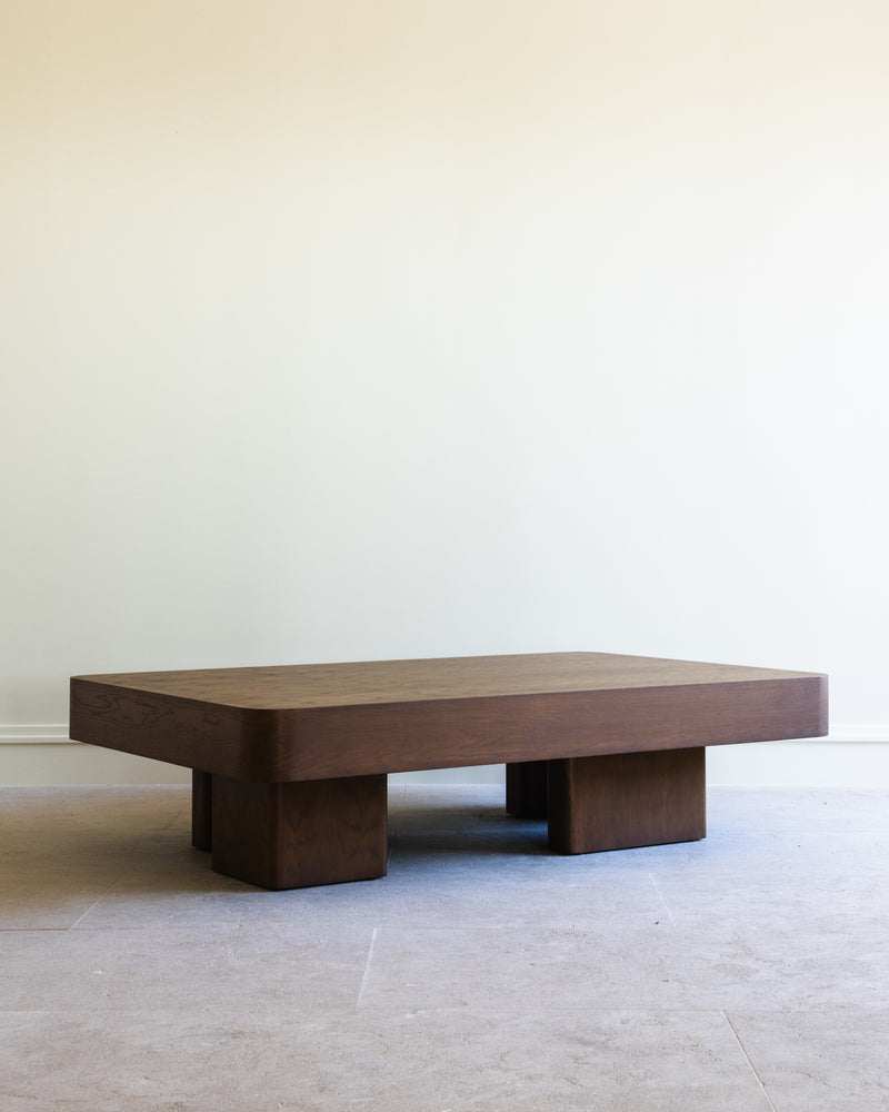 Chalette dark wood coffee table with geometric block base design