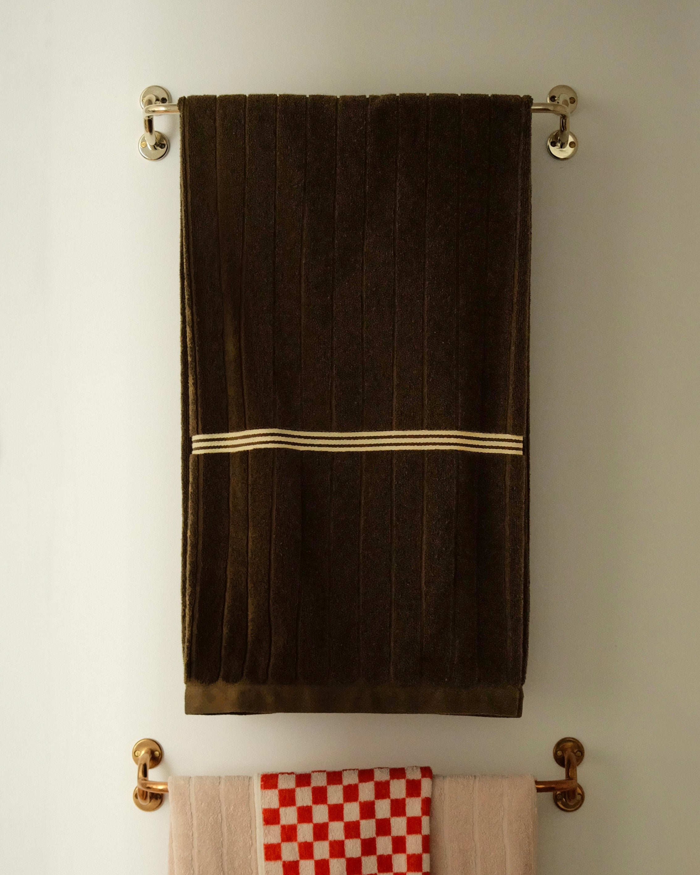 FAUNA Towel Bar (2 sizes) — close-up of brass hardware with towel