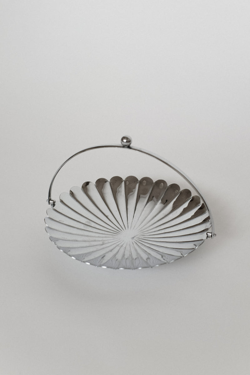 Serving Dish With Handle — close-up of polished metal surface