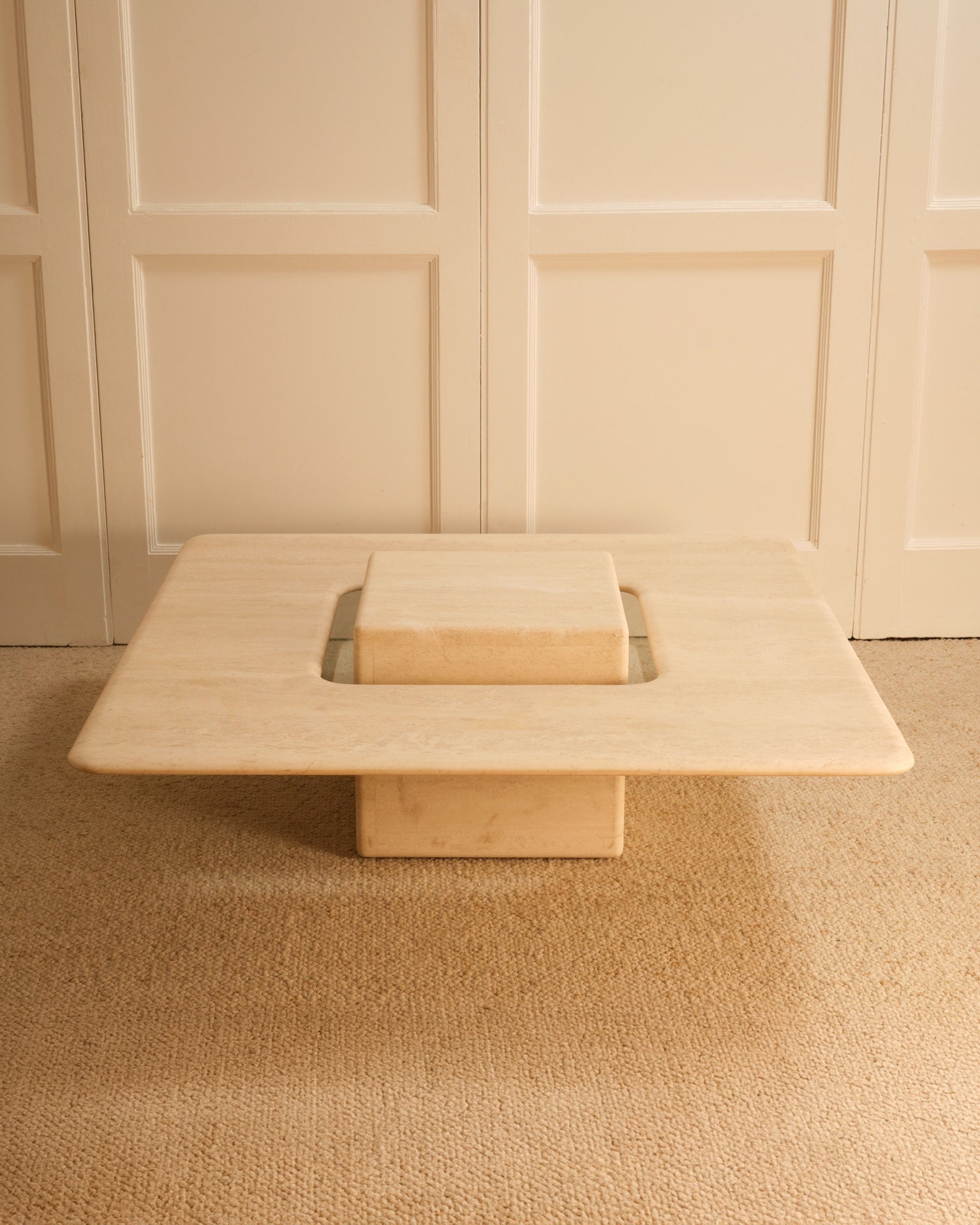 Saturn travertine coffee table with geometric cutout detail
