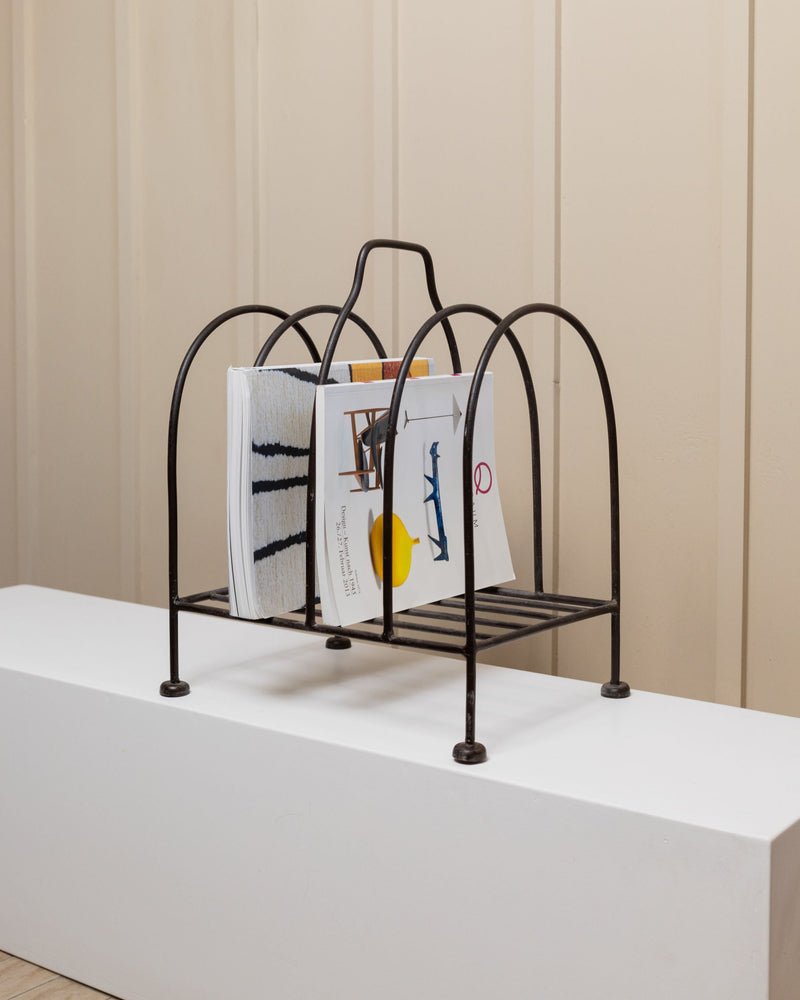 Metal Magazine Rack - Italy 1970s — close-up of black metal frame with magazines