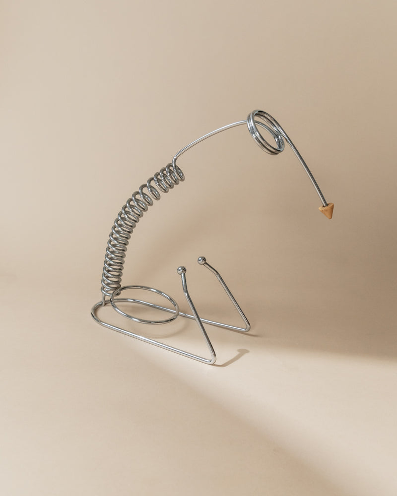 Stainless steel bottle holder sculptural coiled design detail