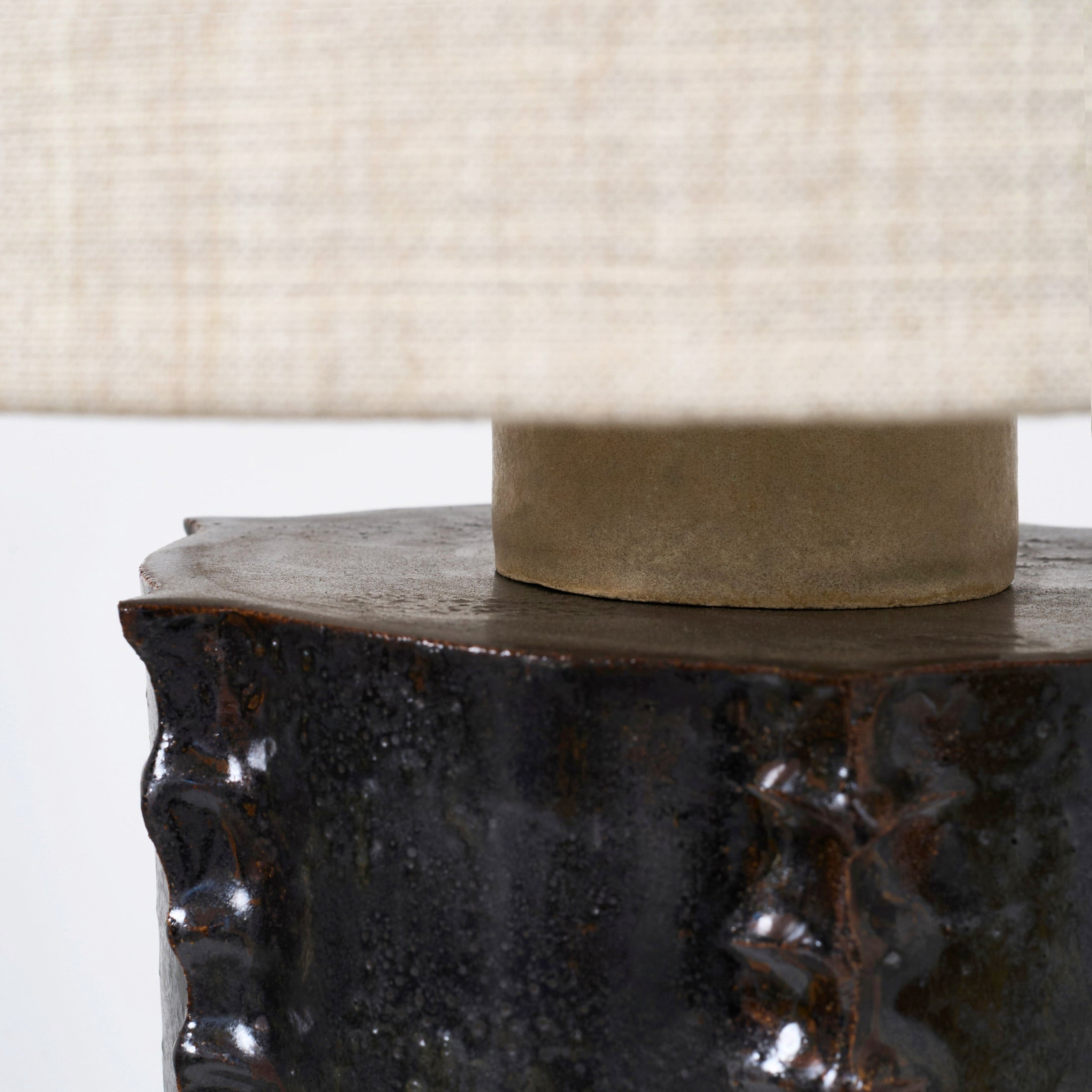 Totem Table Light — close-up of textured ceramic base with linen shade