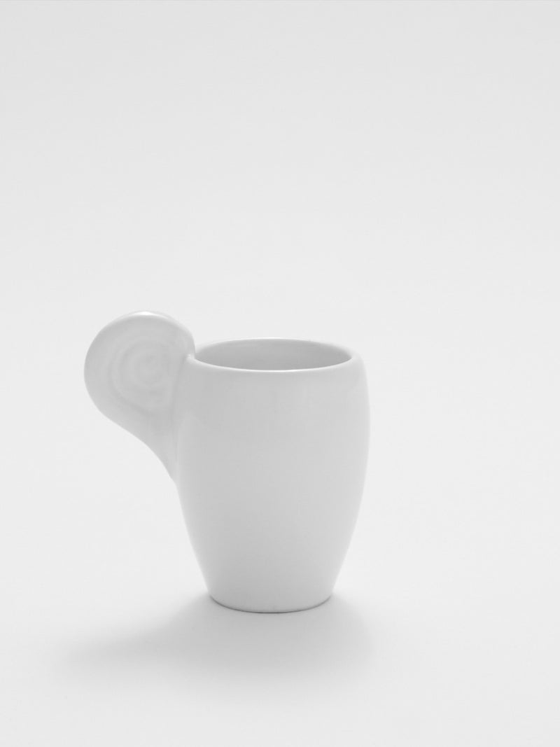 White ceramic espresso cup with distinctive horn-shaped handle