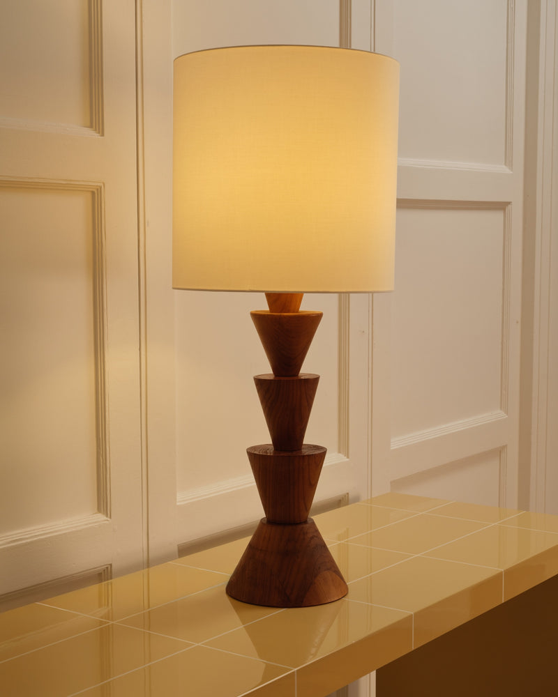 Mid-century wooden table lamp with stacked geometric base and cream shade