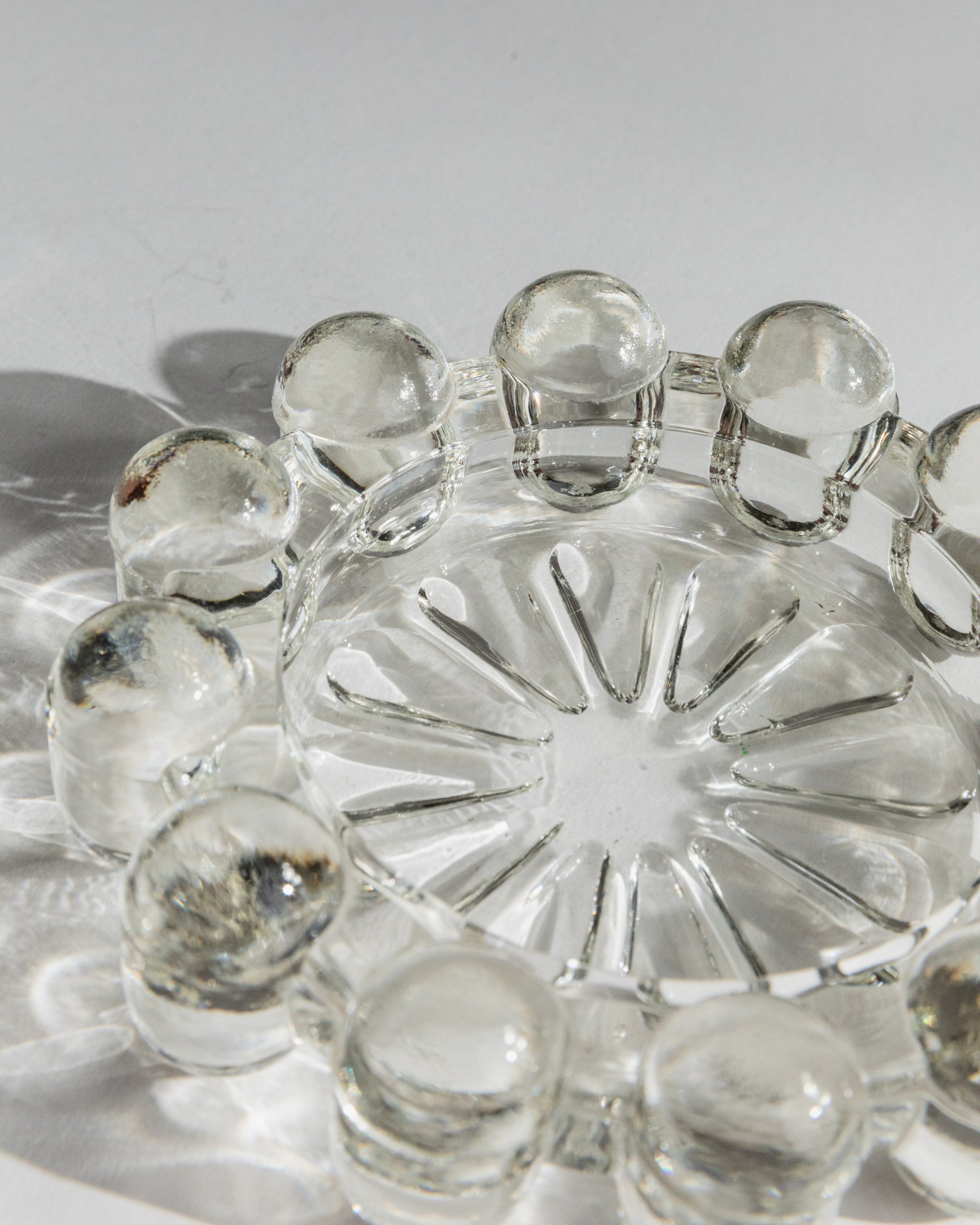 Close-up detail of 1970s Italian art glass ashtray with decorative spherical rim