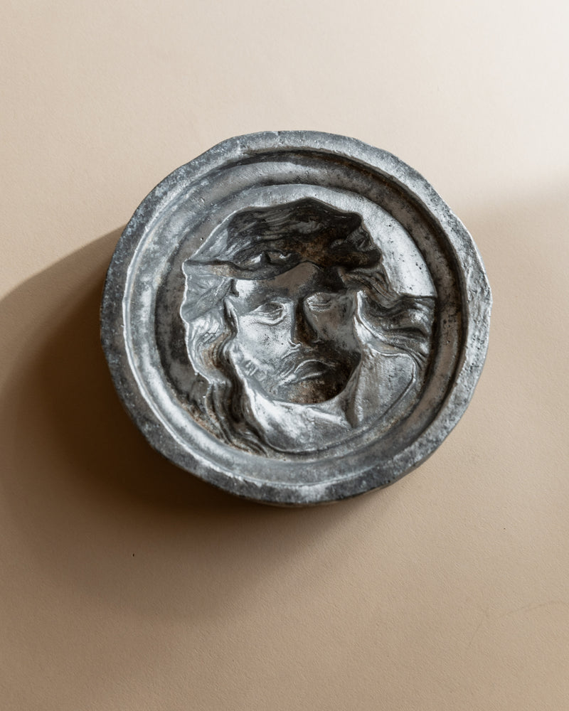 Vintage Italian metal ashtray with embossed face relief, 1950s