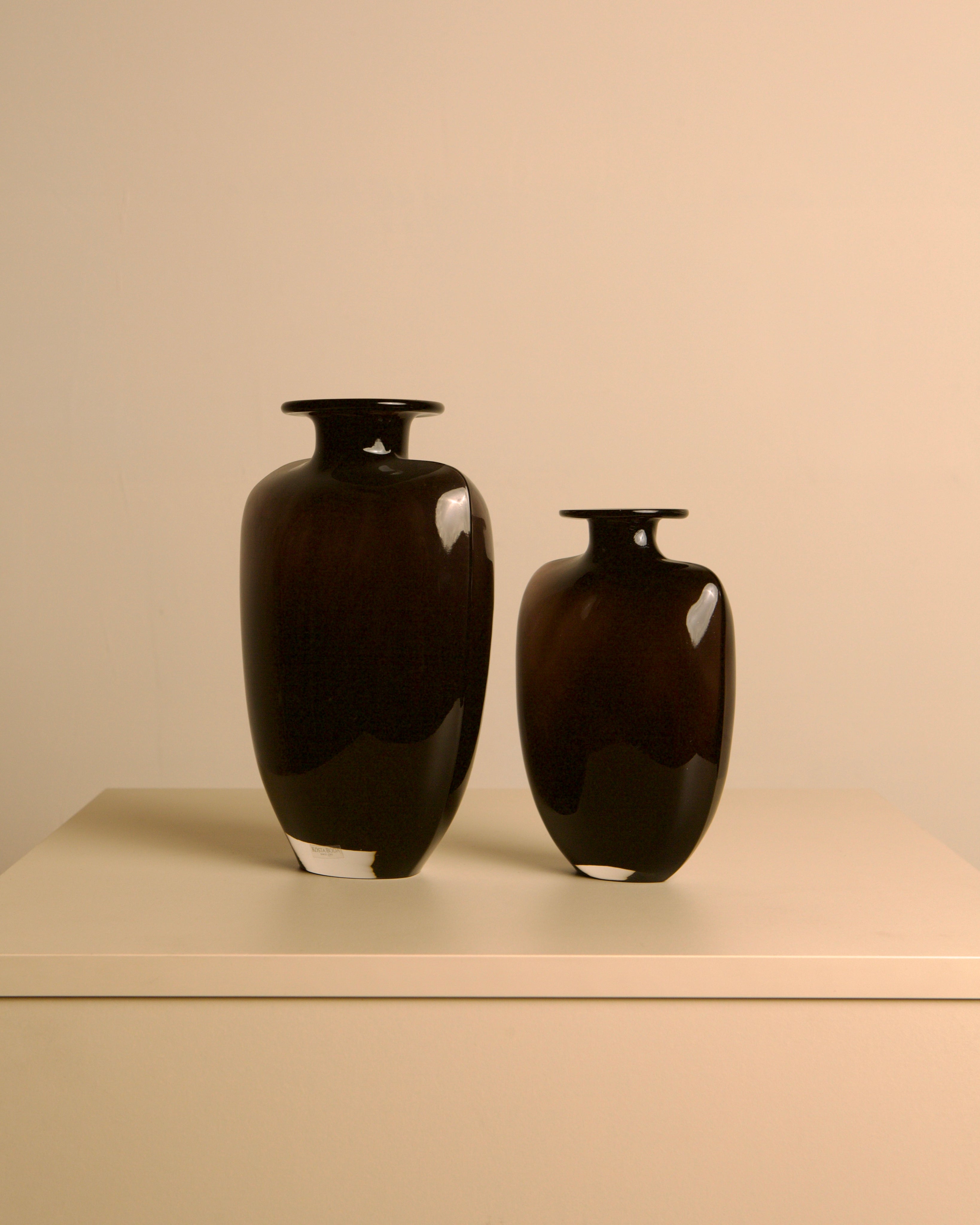 Pair of dark glass vases, Kjell Engman for Kosta Boda, Sweden, 1980s — lifestyle setting