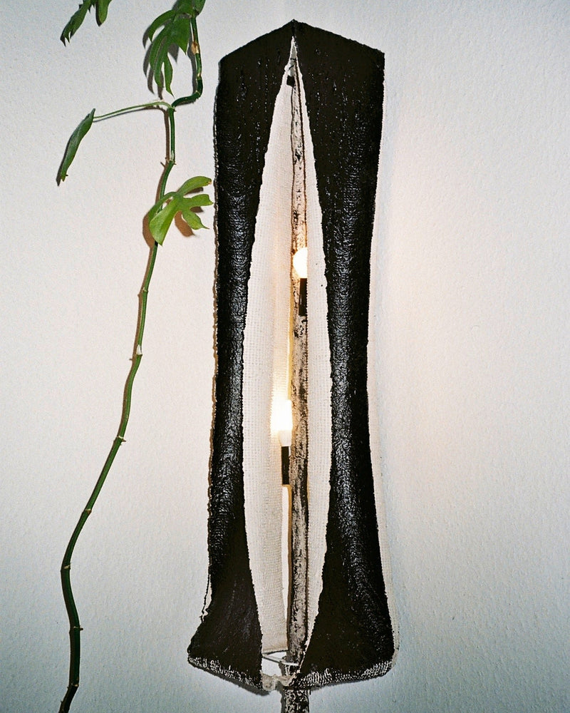 Rebirth I floor lamp detail showing textured black exterior and interior wood structure