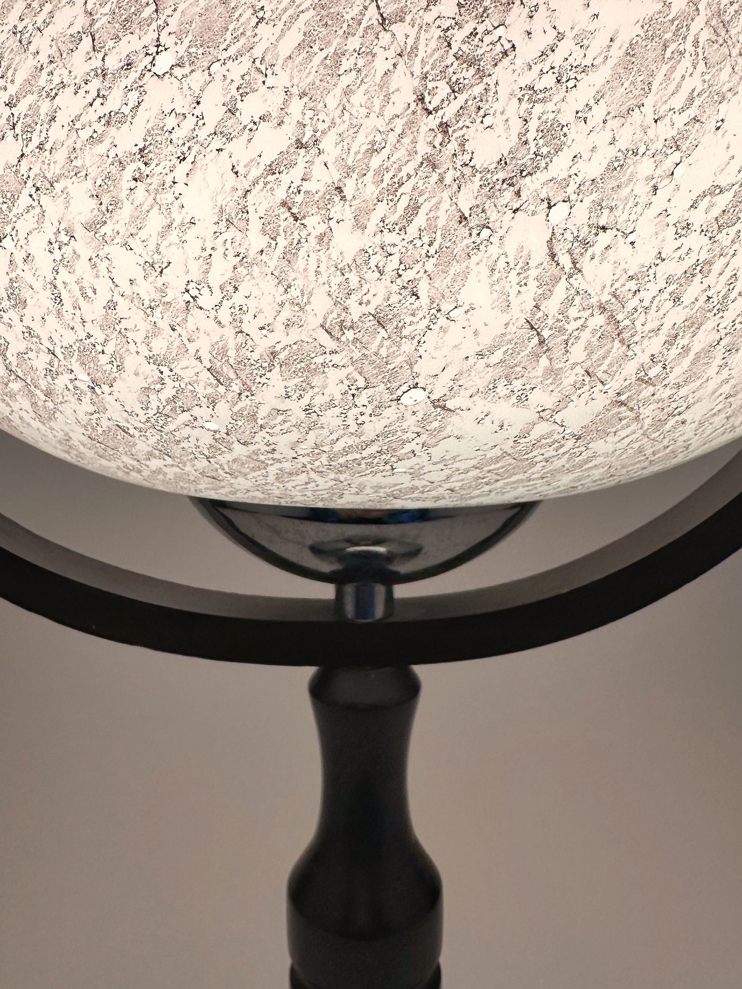 A close-up of the Dodo Vintage 1960s Sputnik Age Table Lamp, featuring a textured speckled white glass shade and black metal base, displayed against a plain background.