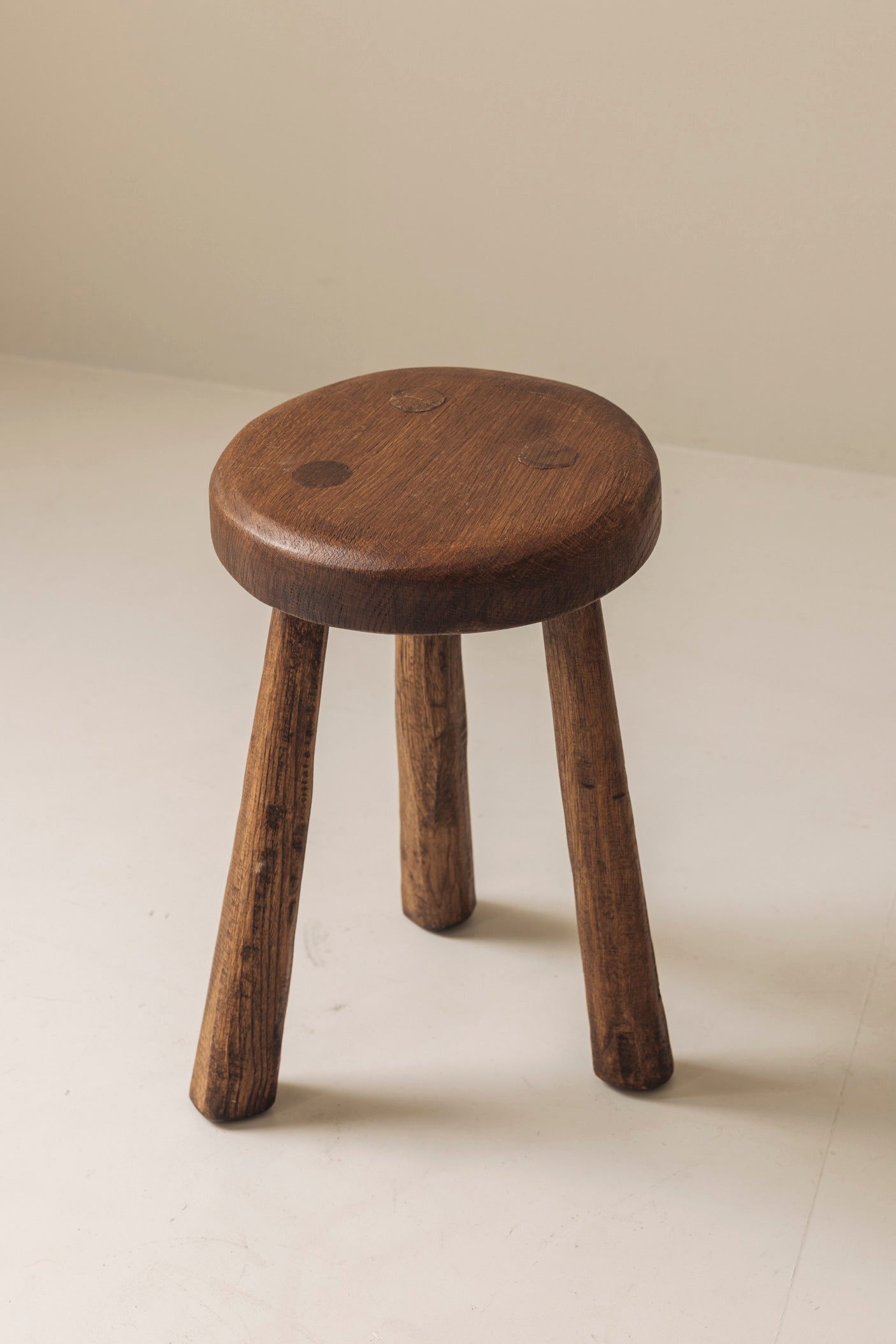 Set of two solid elm tripod stools from France, 1950s — alternate view