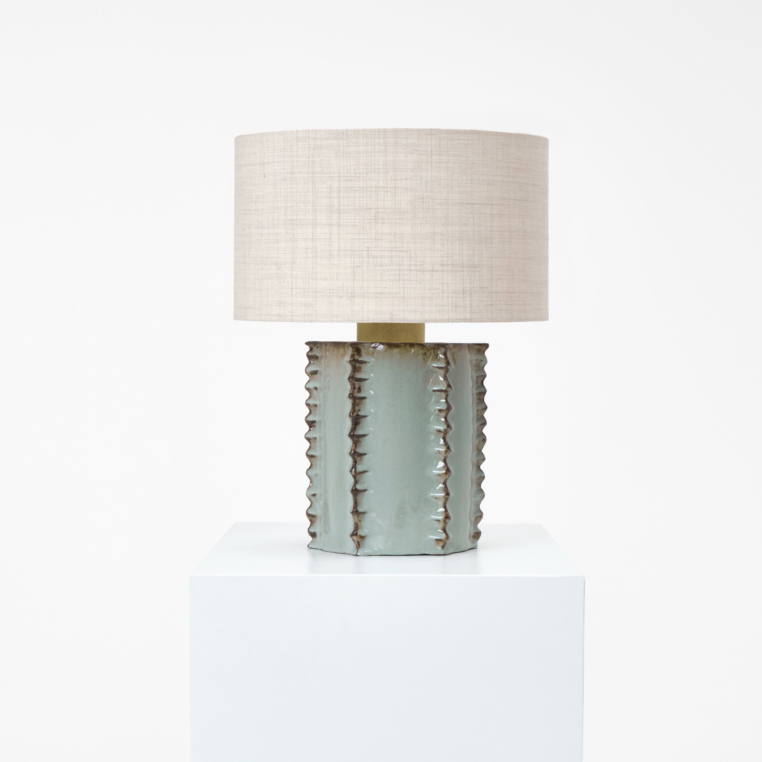 Totem Table Light — top view of textured ceramic base with linen shade