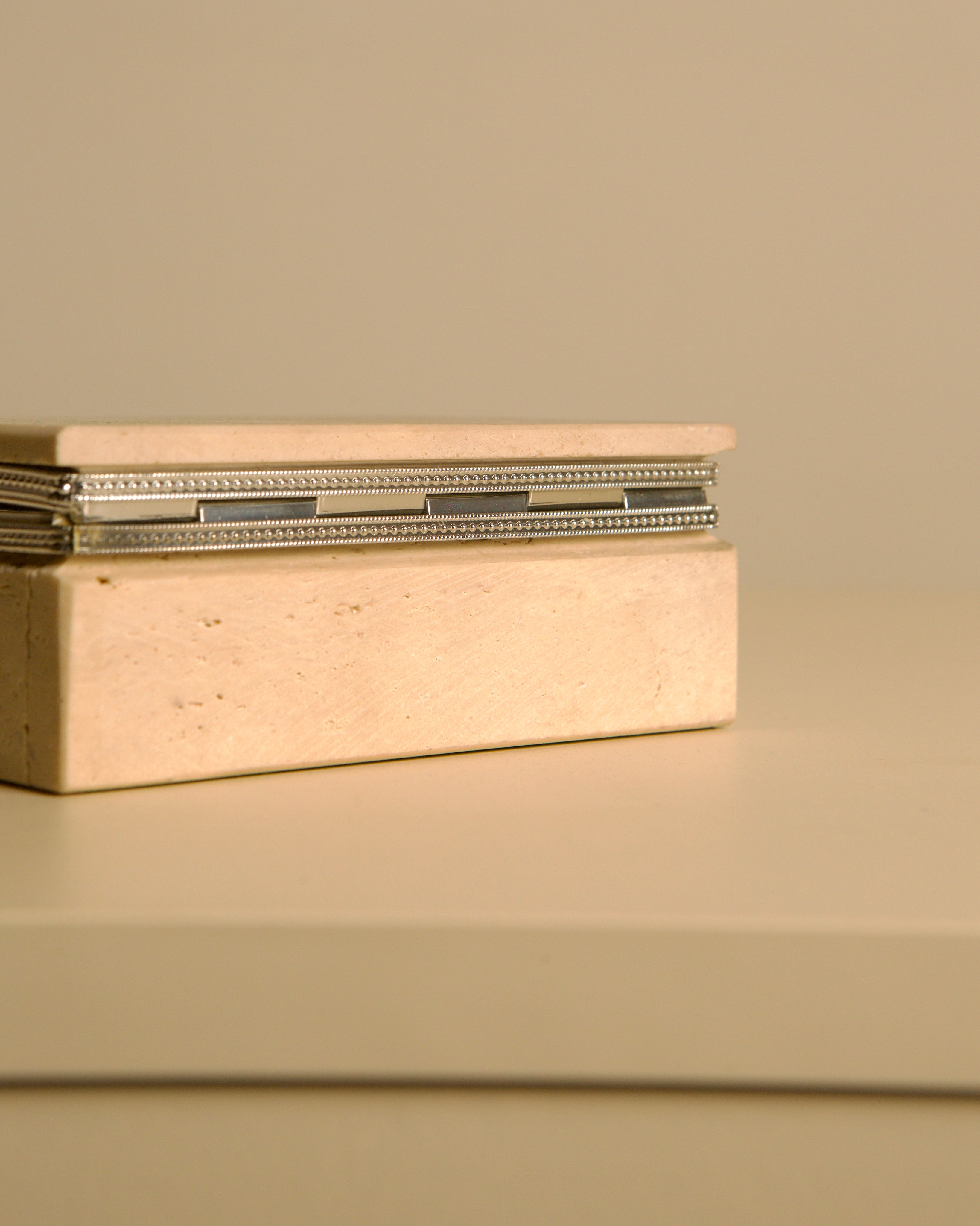 Italian Travertine Box, 60s — top view with metal accents on beige surface