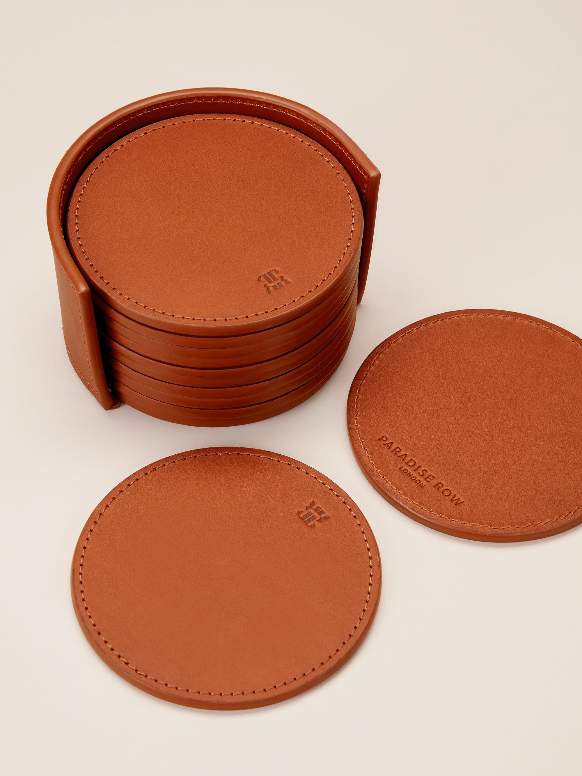 Leather Coasters in Holder (set of 12) — top view of tan leather coasters