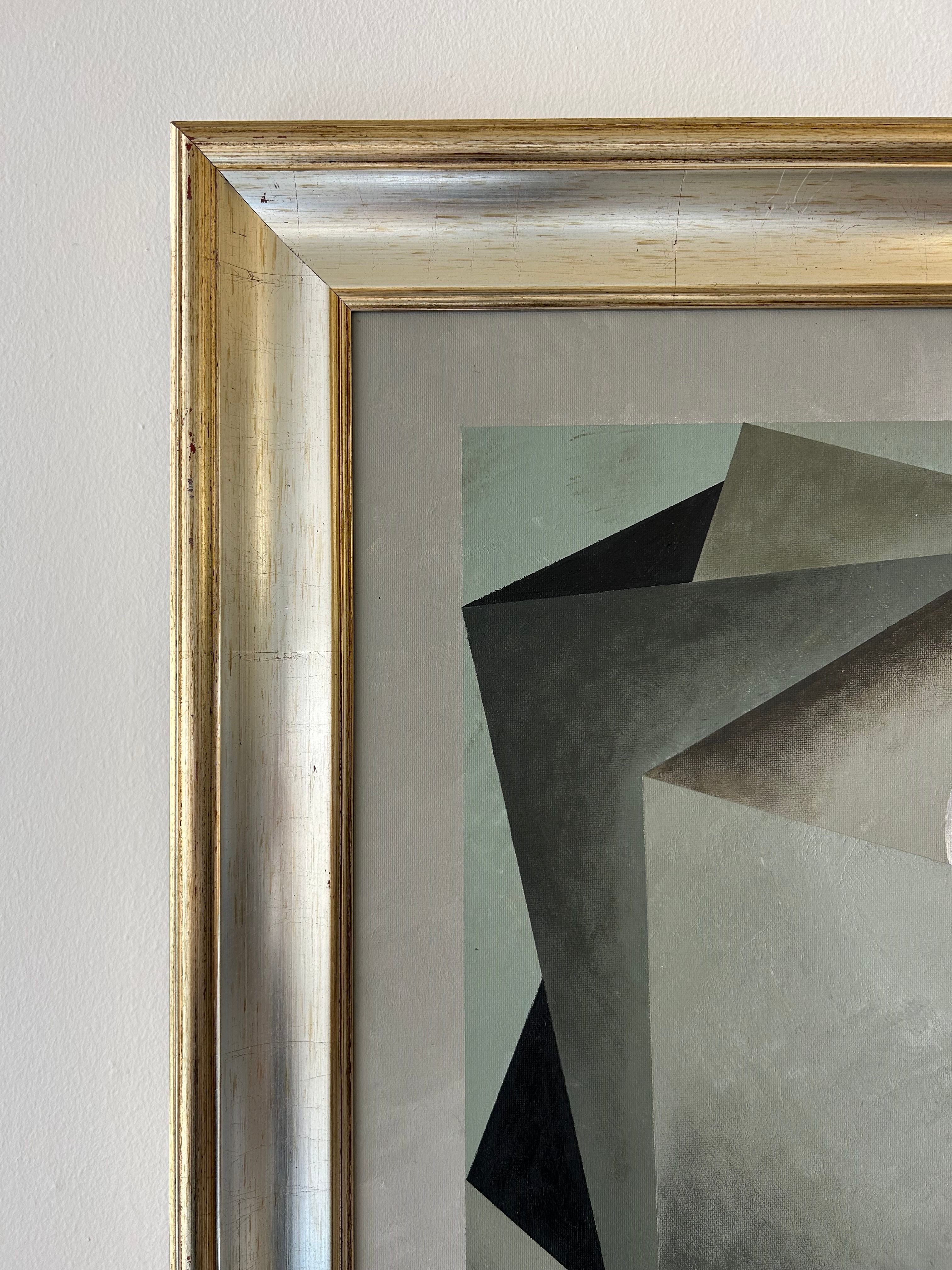 A close-up of the gold frame on a light wall, showing the top left corner of Iris Bavelaar's "Nest" painting—contemporary classic linen wall art with overlapping gray, black, and forest green shapes.
