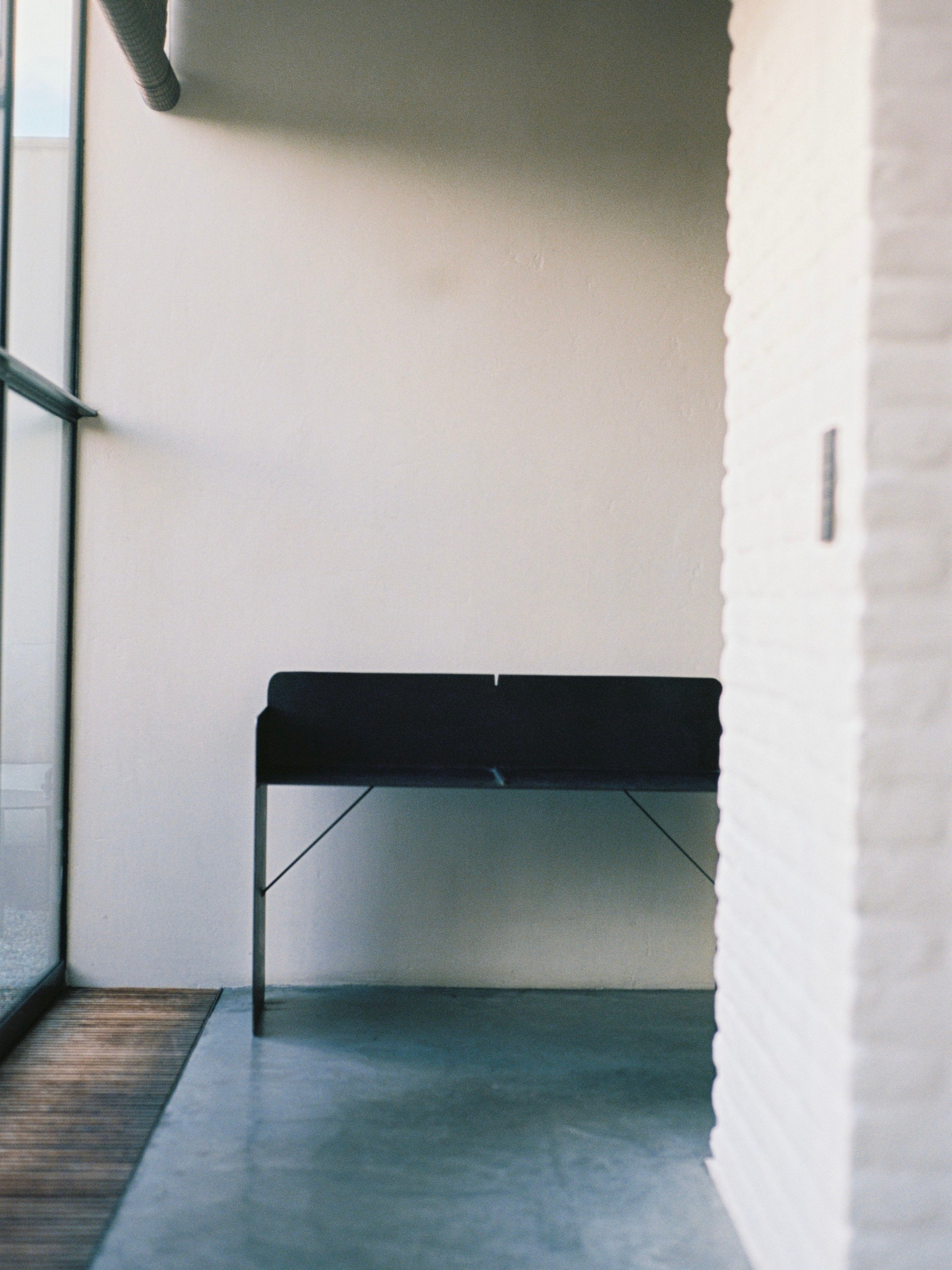 The Bench - Brutalist Bench in Steel — corner view in minimalist interior