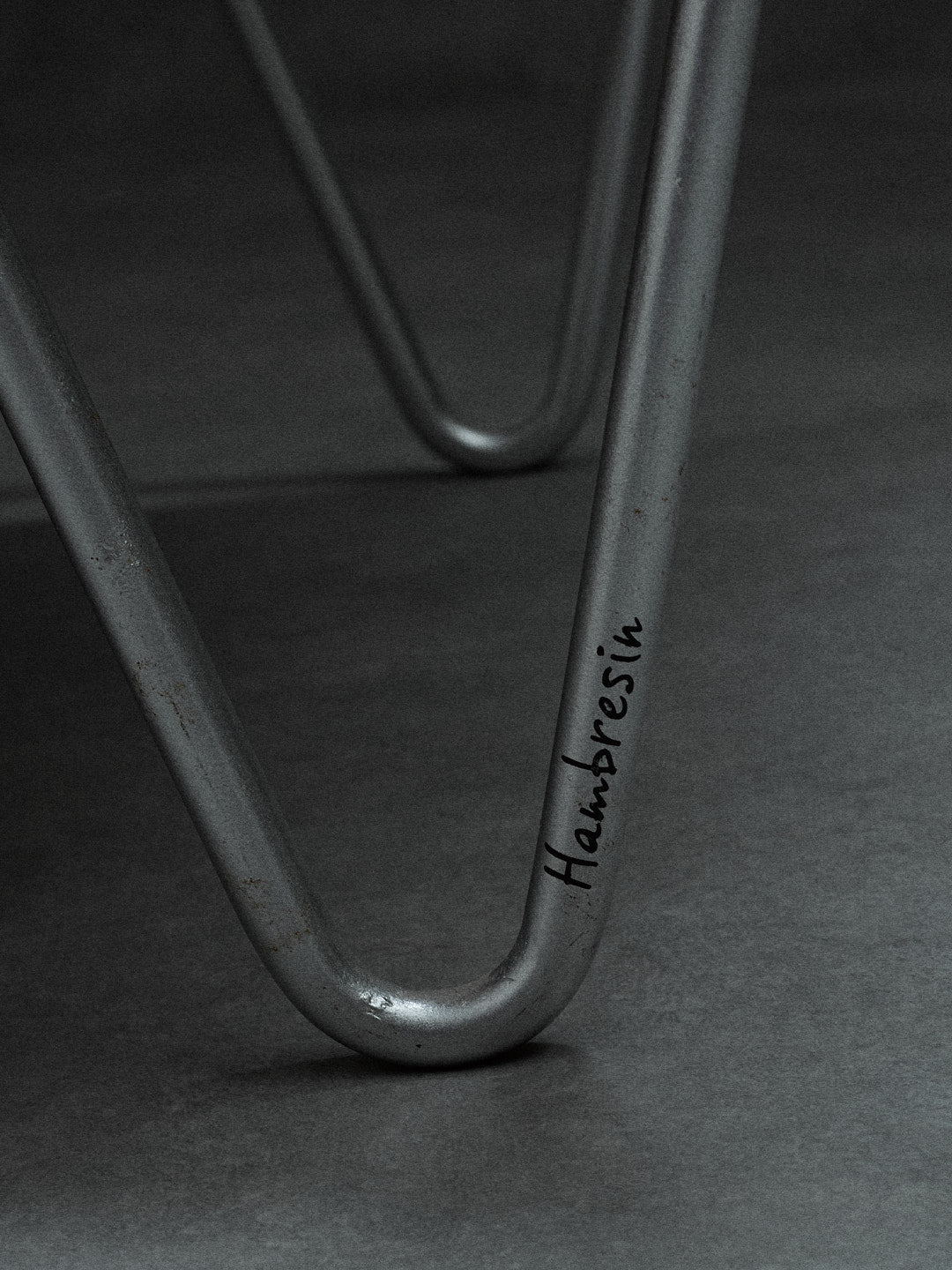 bamboo lounge chair, signed "Hambresin" — close-up of metal leg detail