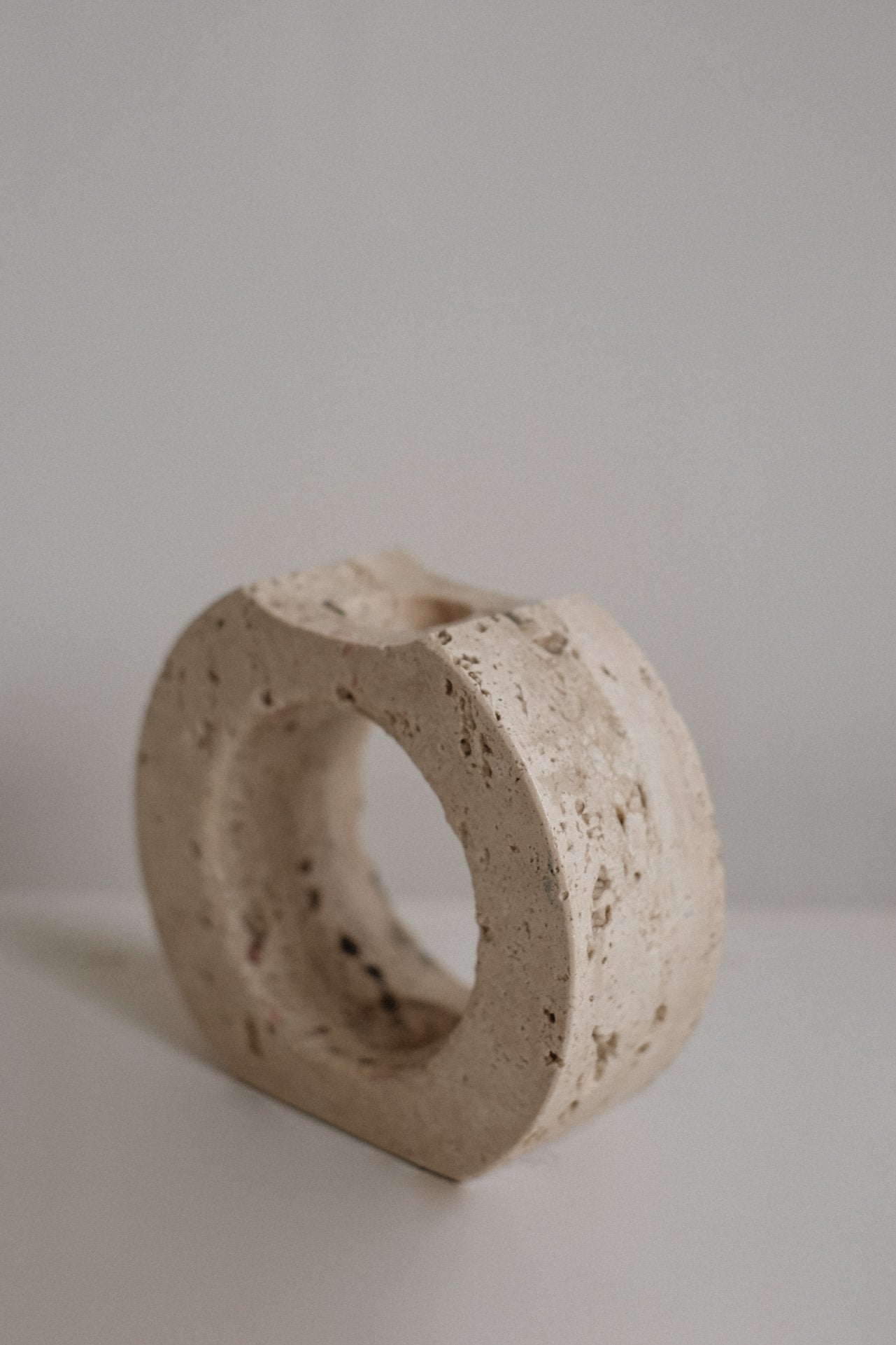 Travertine Candle Holder — angled view on neutral background