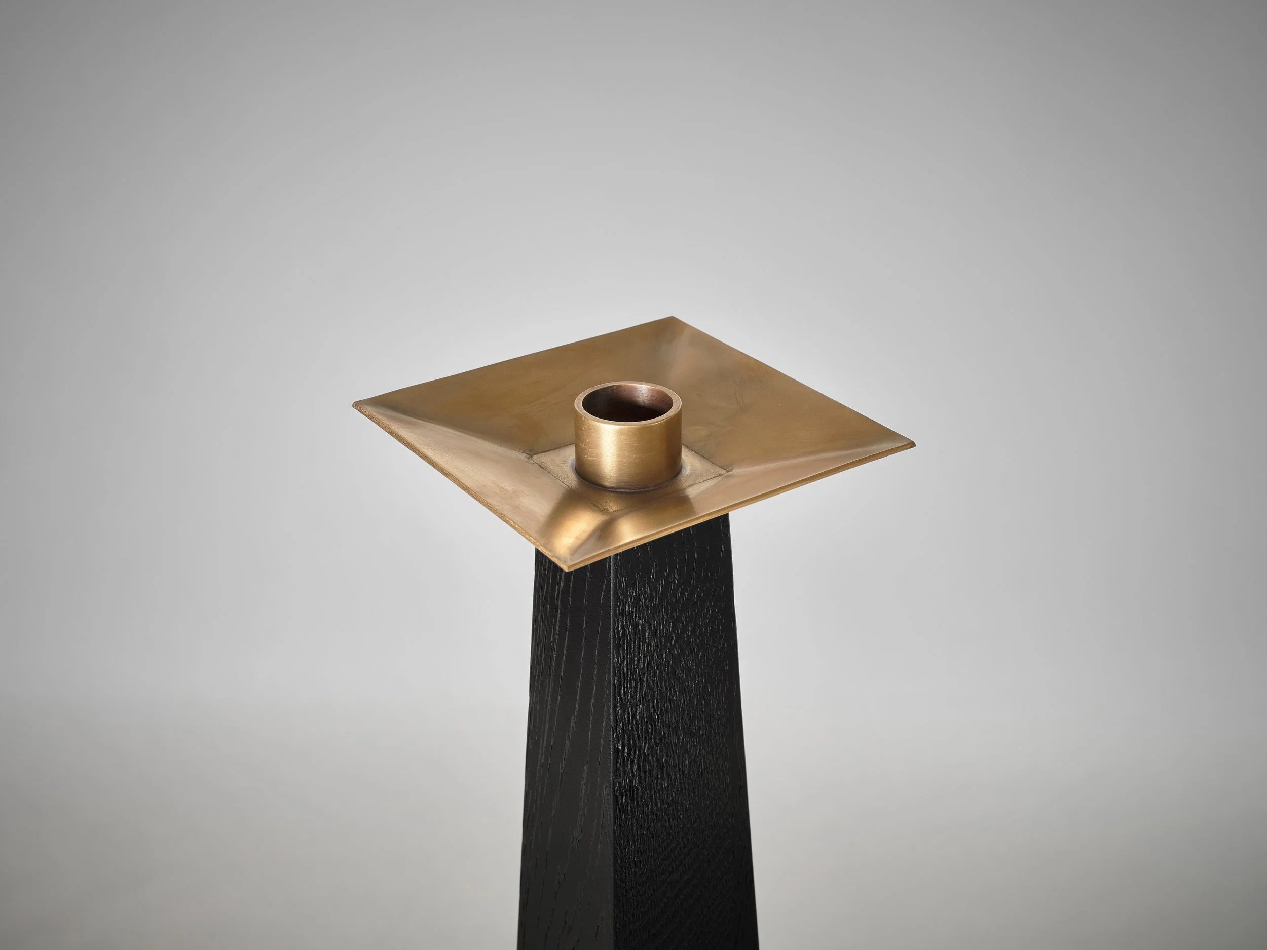 Taes Candle Holder — top view of brass holder on black base
