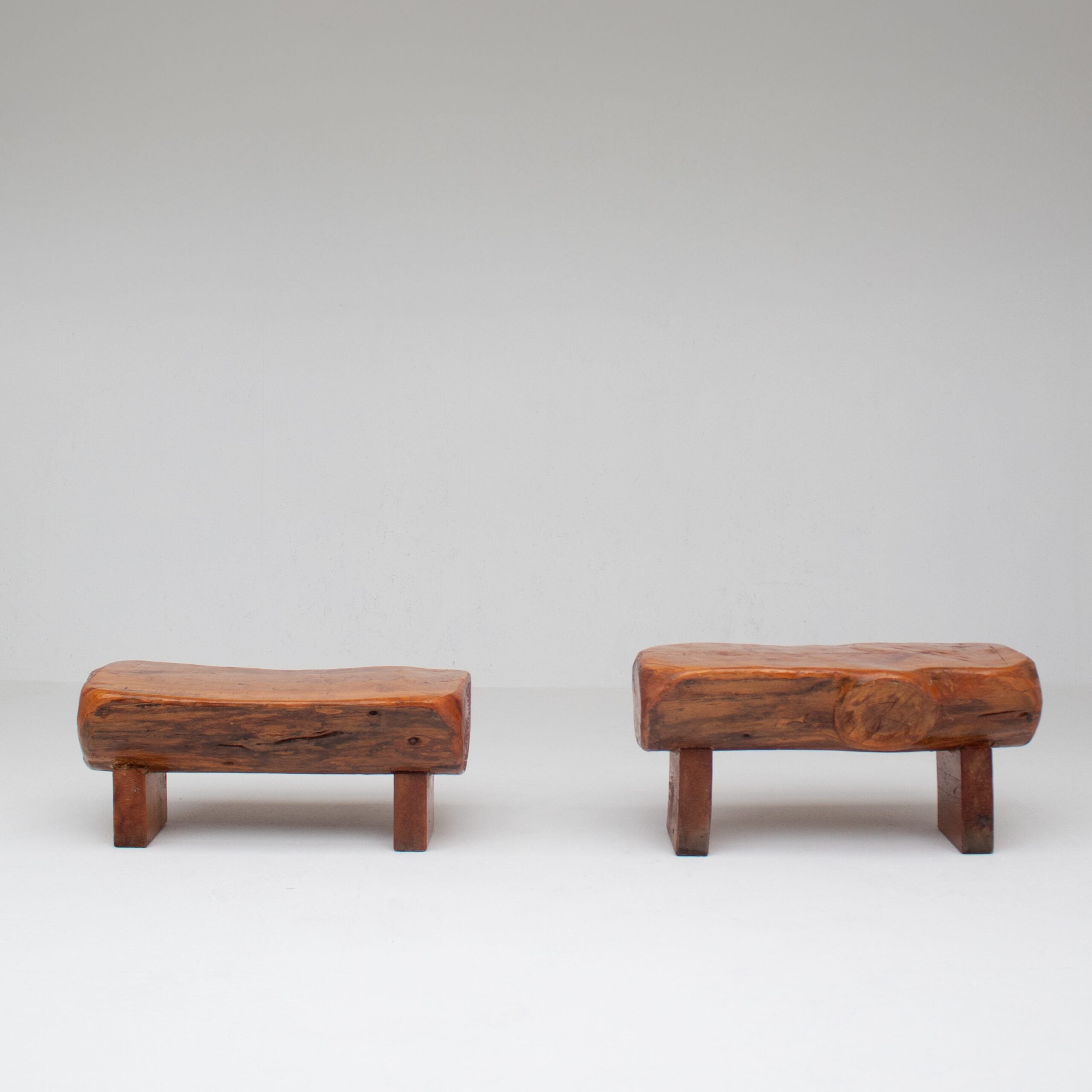 Pair of Rustic Wooden Sculptural Benches in Solid Wood — angled view on white background