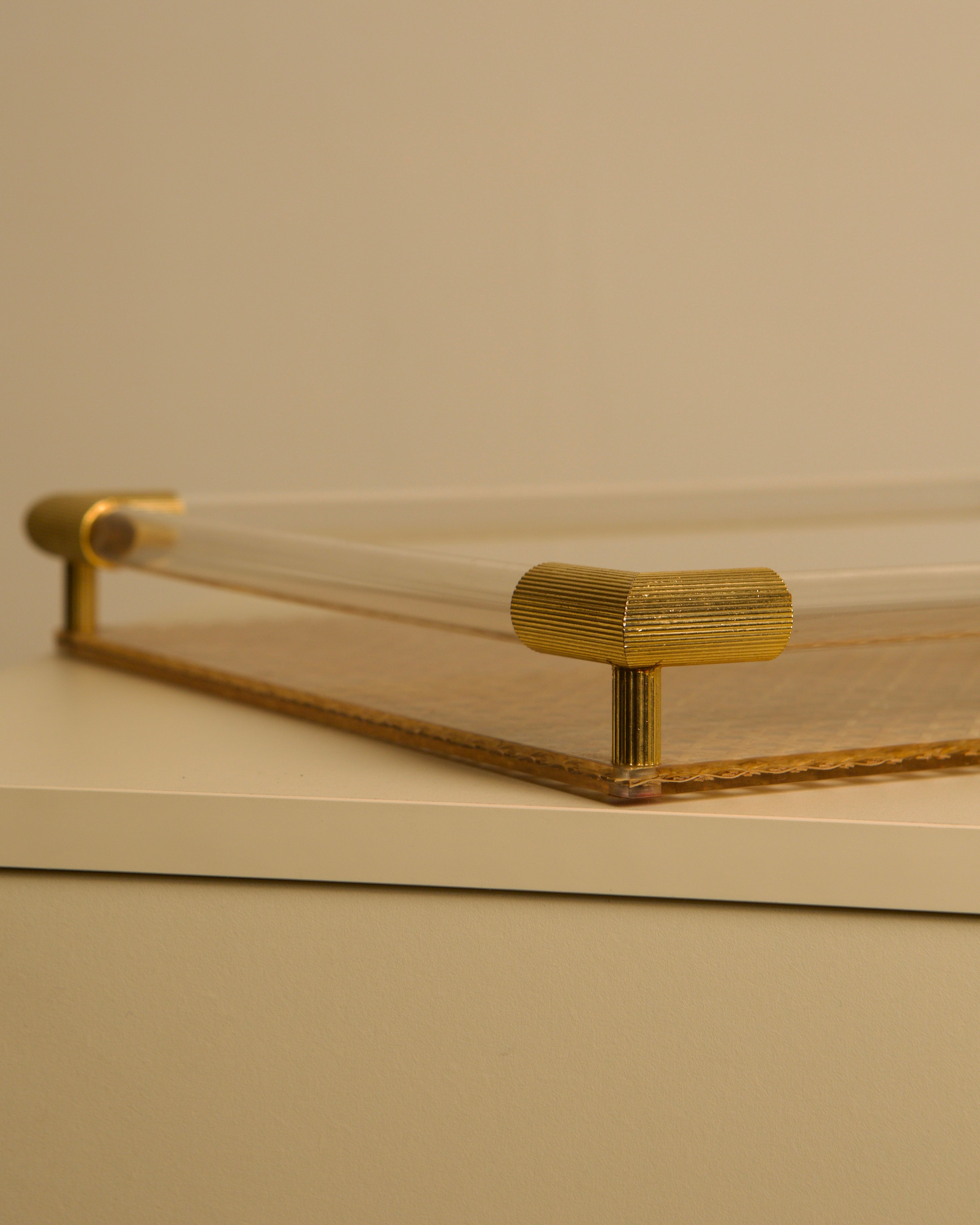 Large Italian 70s Brass, Wicker and Plexiglass Catch-all Tray — angled view highlighting brass corners and wicker base