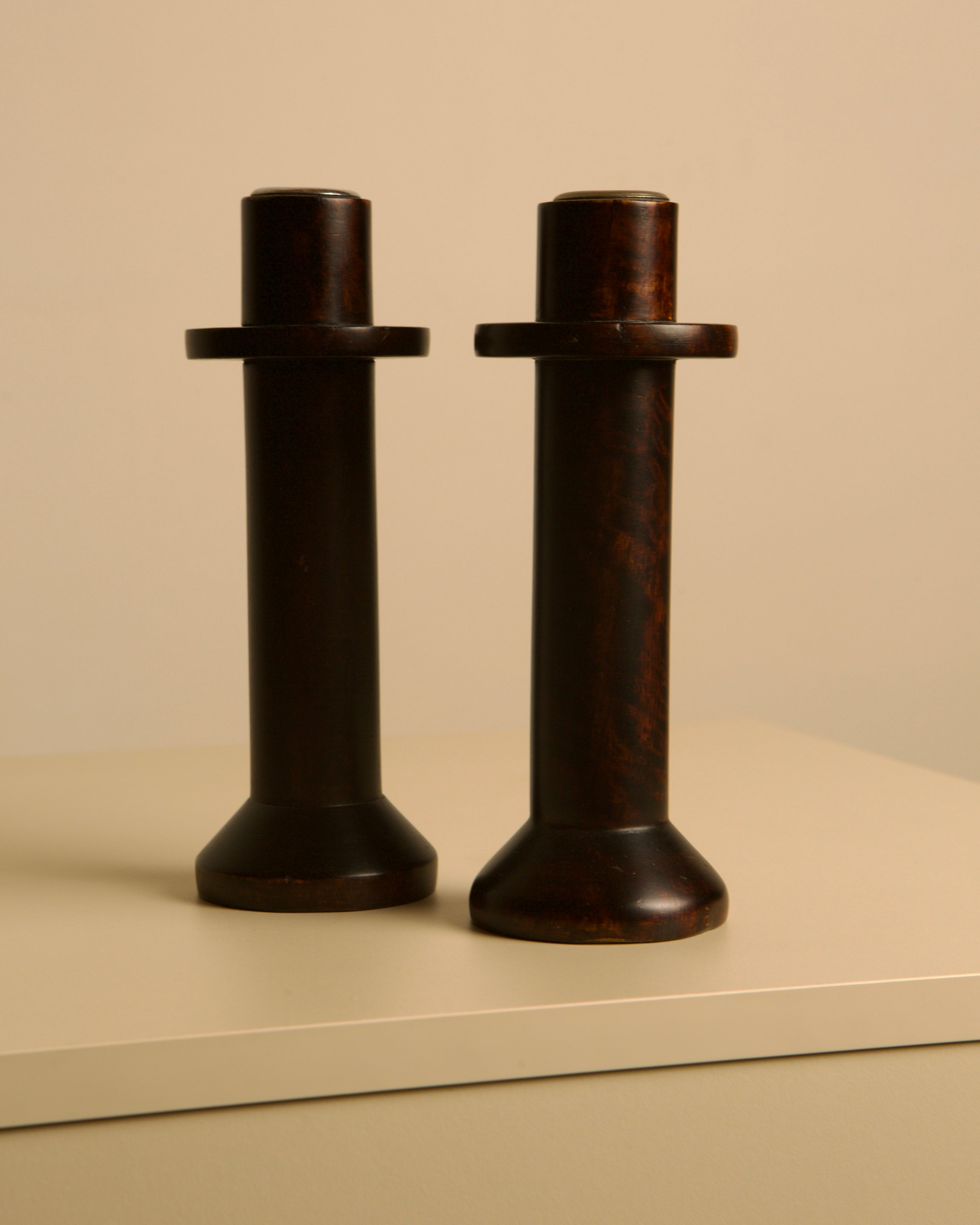 Pair of Italian Wooden Candlesticks from the 80s — side angle on neutral background