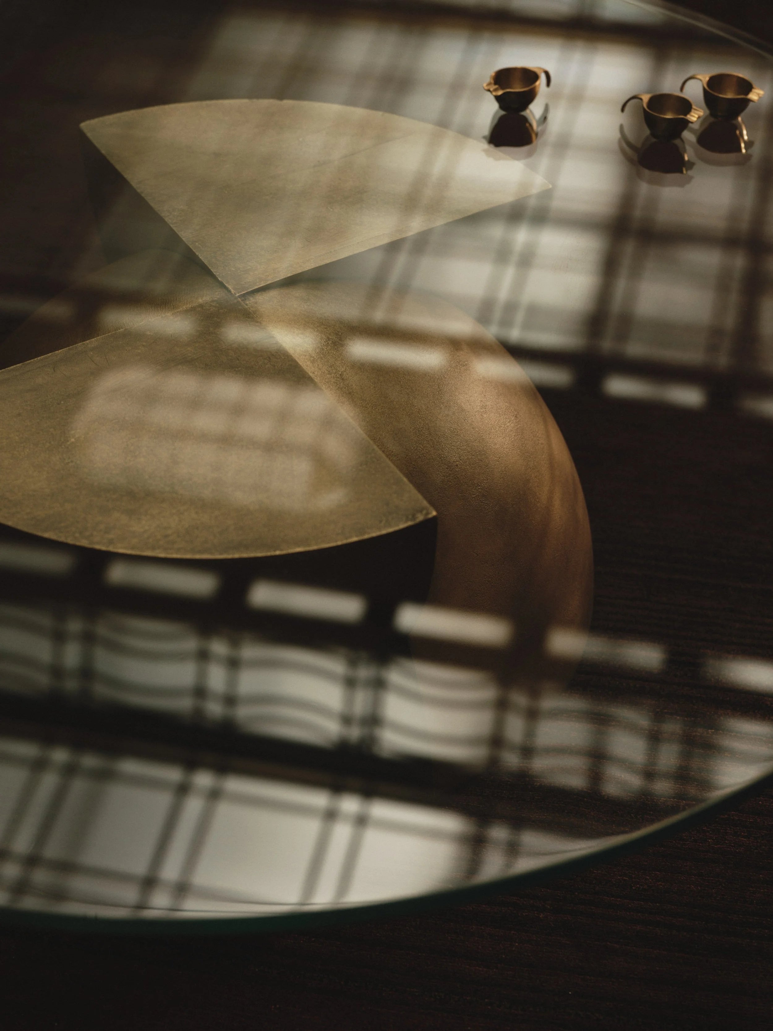Axis Coffee Table in Glass and Cast Brass by Studio Brocky — lifestyle setting