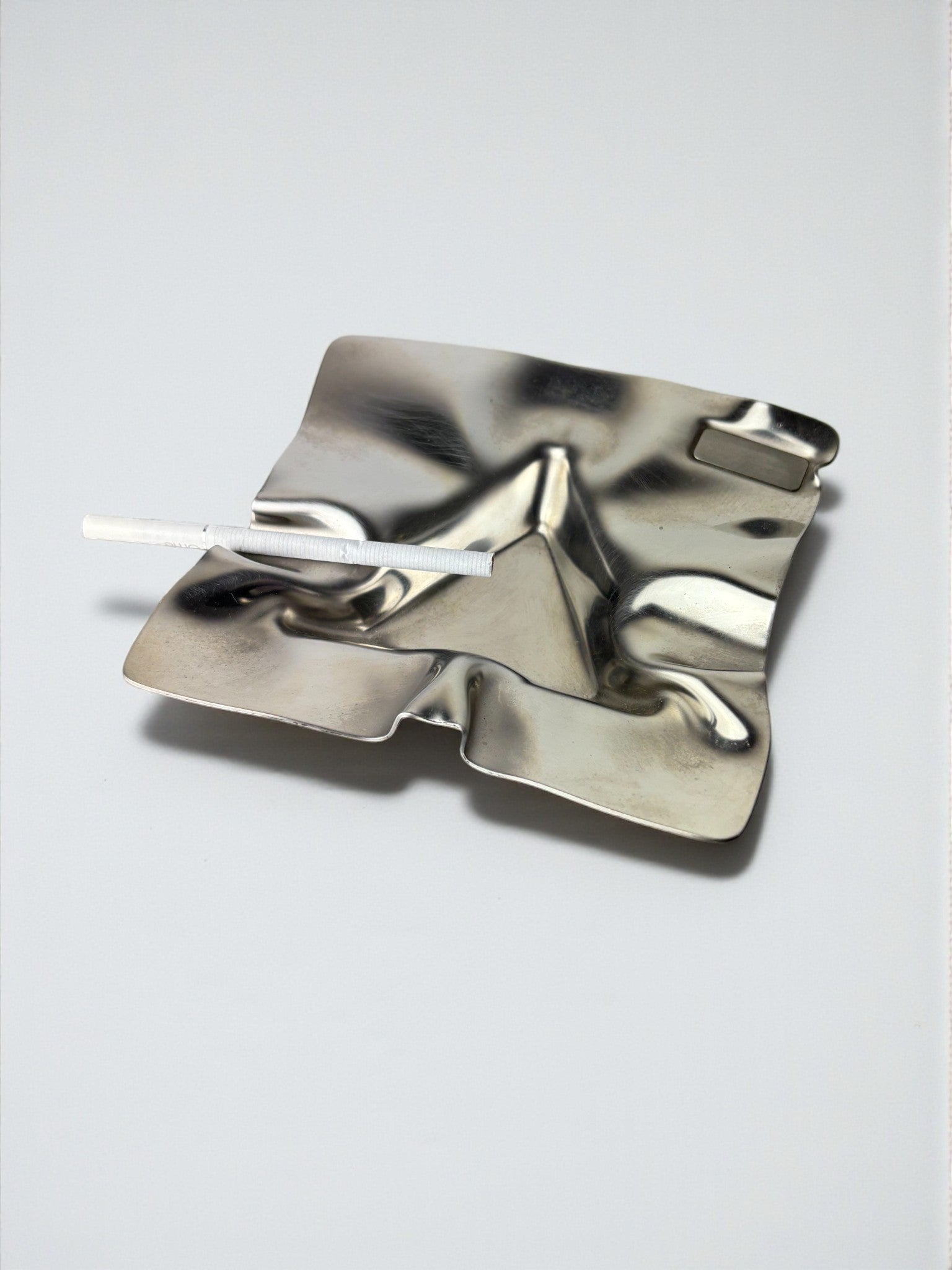 Biomorphic Ashtray, Stainless Steel, Spain, 1970s — angled view on white background