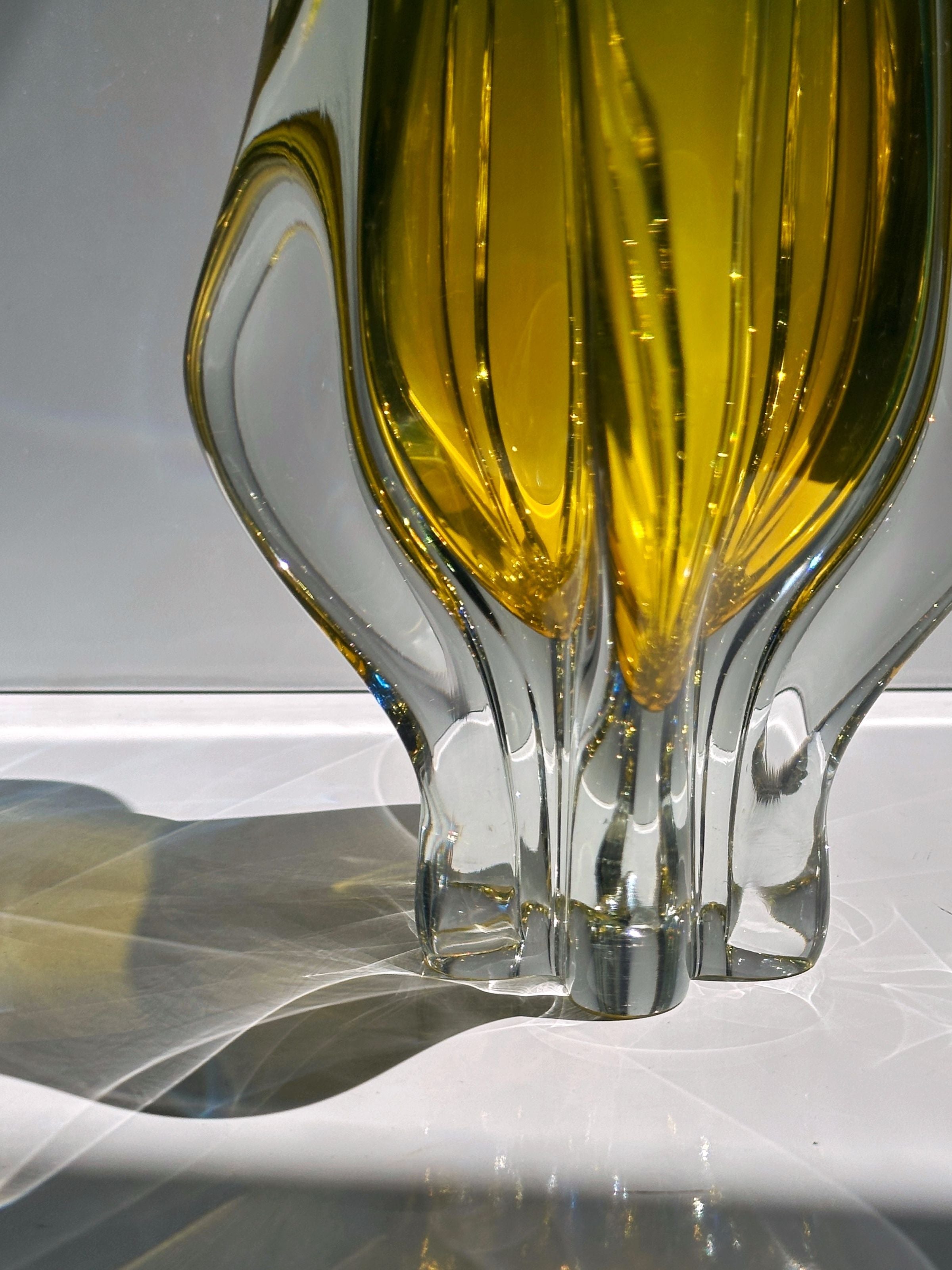 Large amber Bohemian glass vase base detail showing crystal clarity