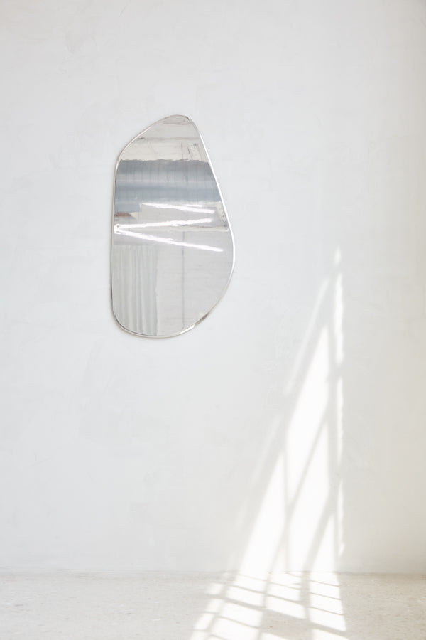 Geo Mirror in Polished Aluminum — wall-mounted with reflective surface against white backdrop