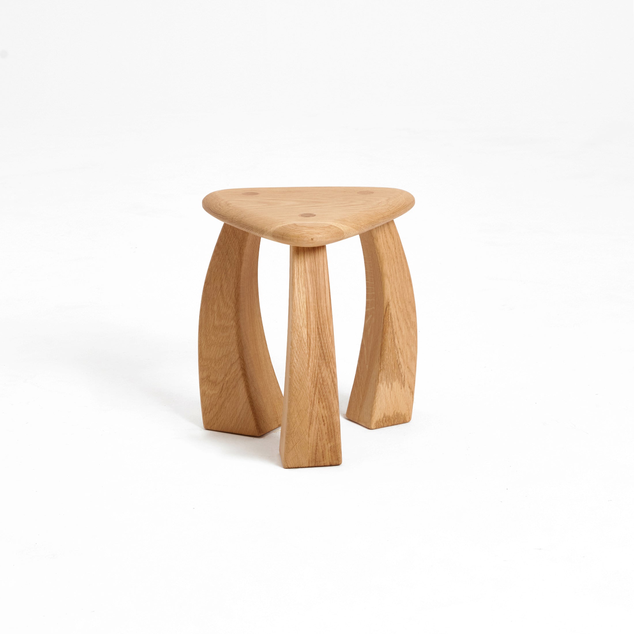Arc de Stool '37 — angled view of natural oak triangular seat