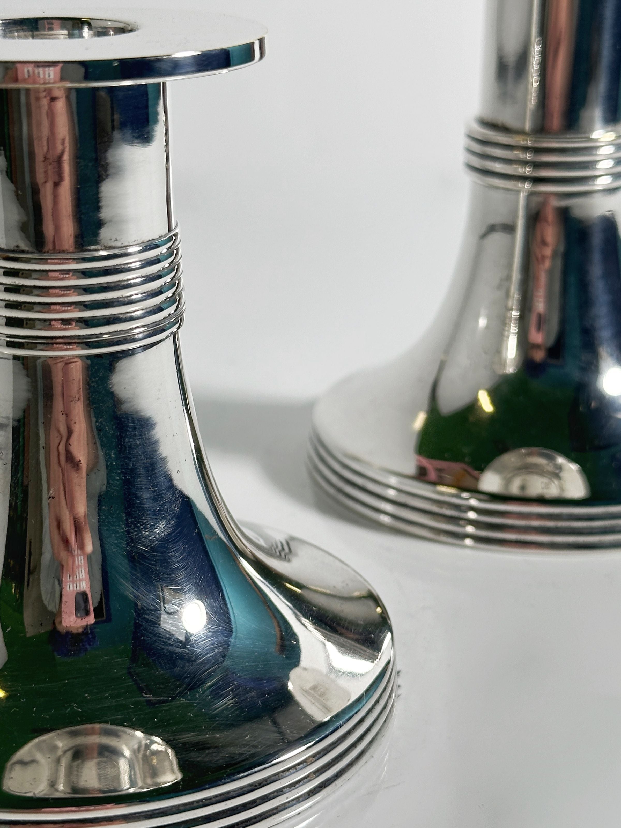 Pair of Silver Plated Candleholders by Gunther Lambert — close-up of reflective silver surface