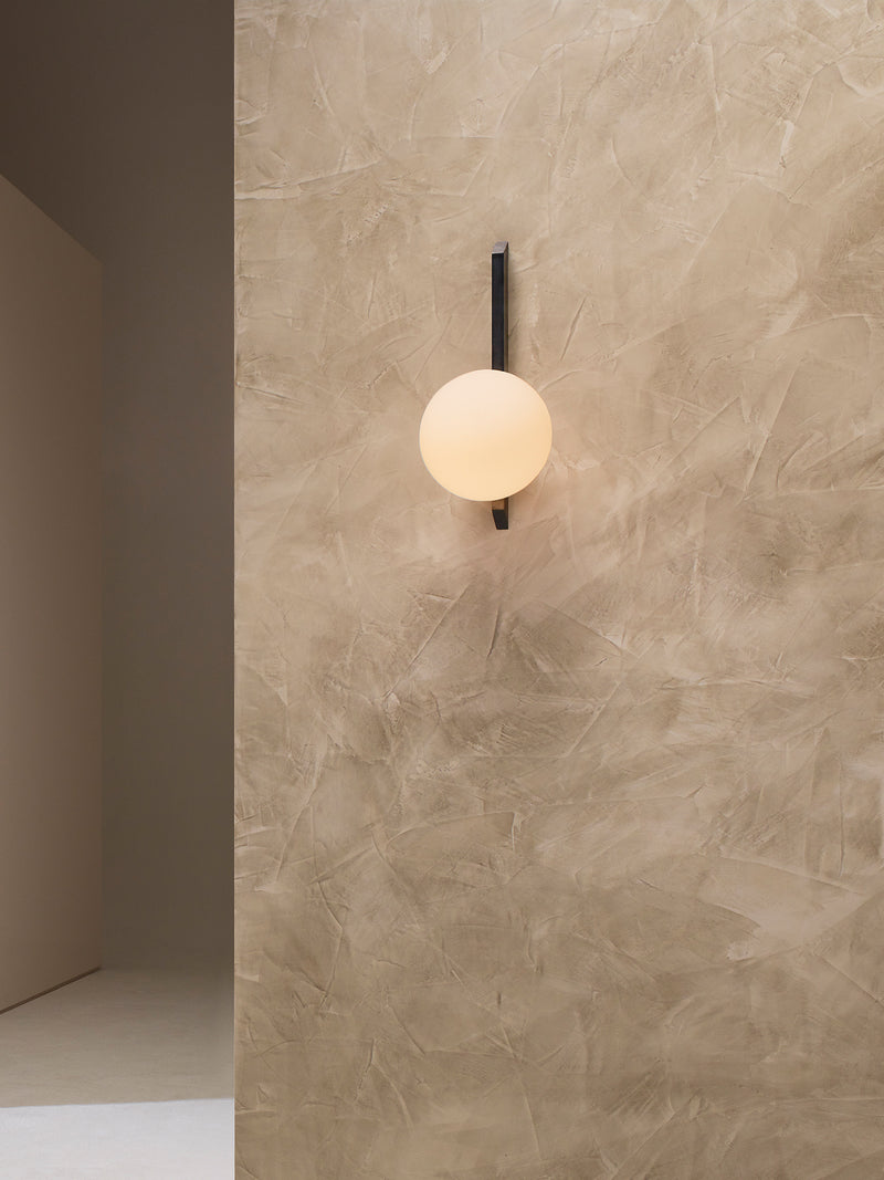 GAIA Wall Tall - Flush — close-up of round glass shade on textured wall