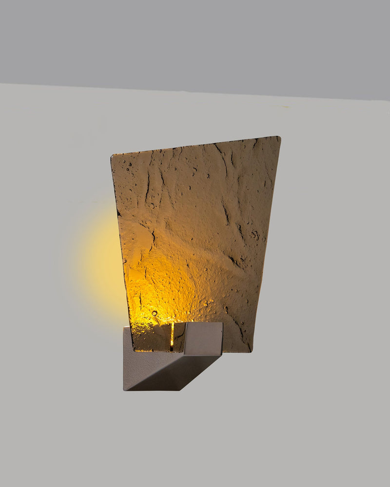Relic wall light with textured amber glass shade and warm glow
