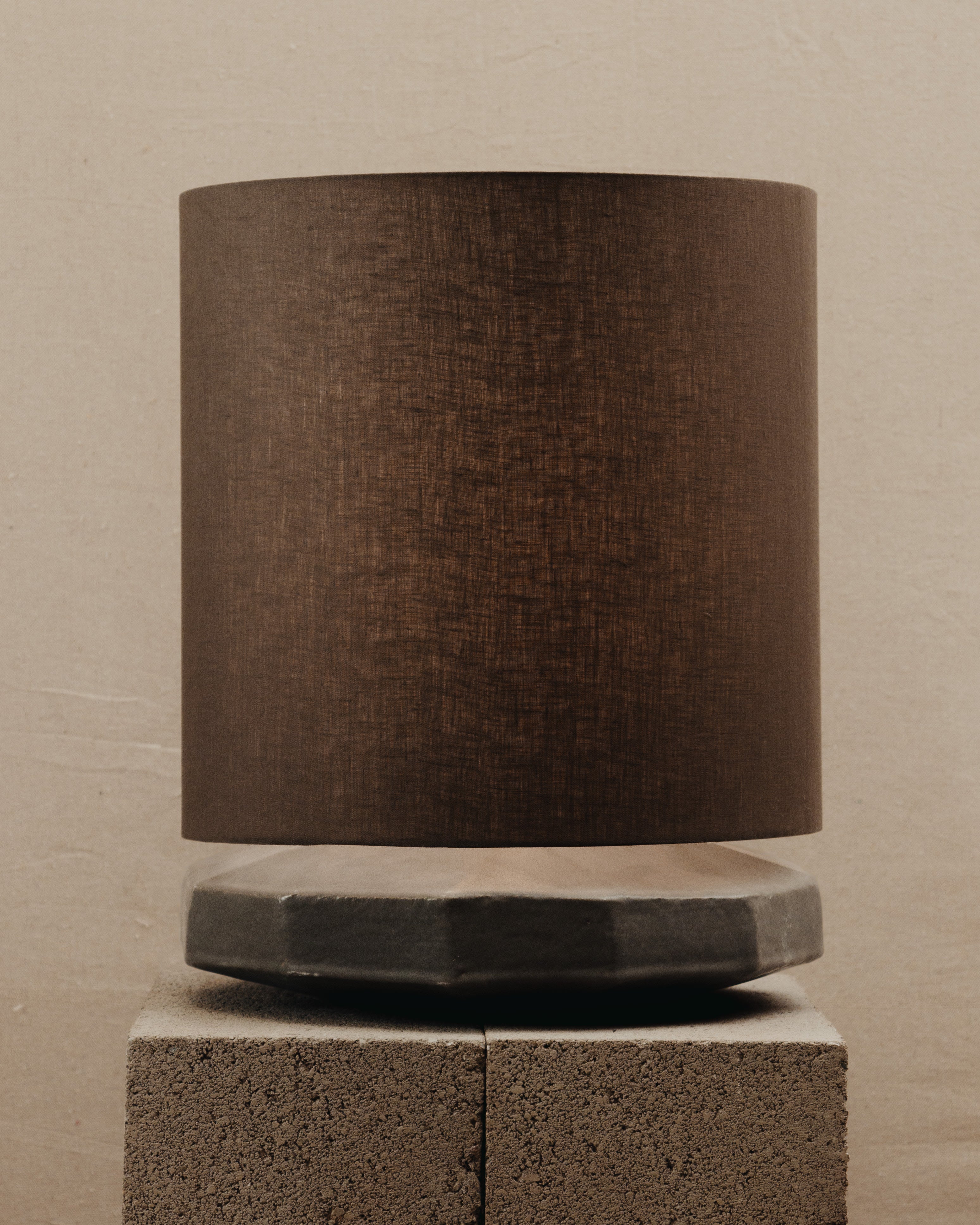 Radian Lamp — side angle showing textured brown shade and concrete base