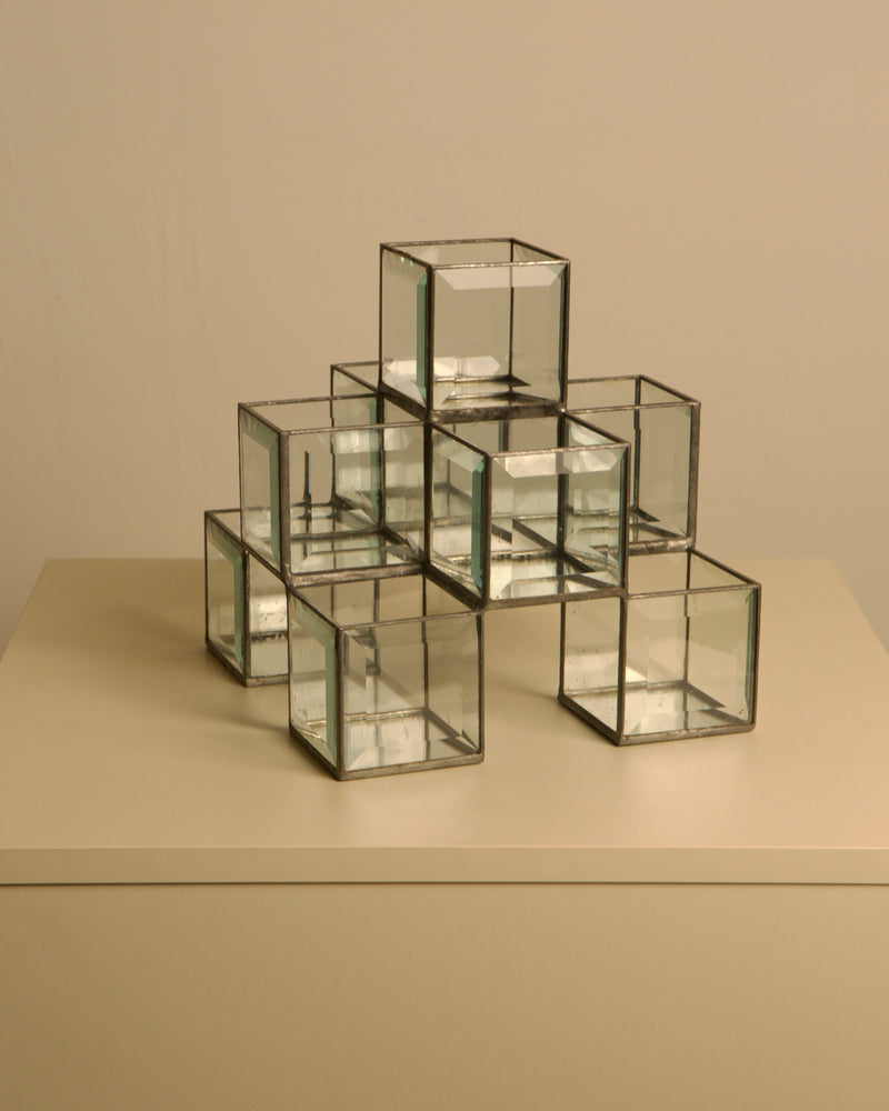Italian handcrafted metal and glass candle holder from the 70s — close-up of glass cubes on neutral background