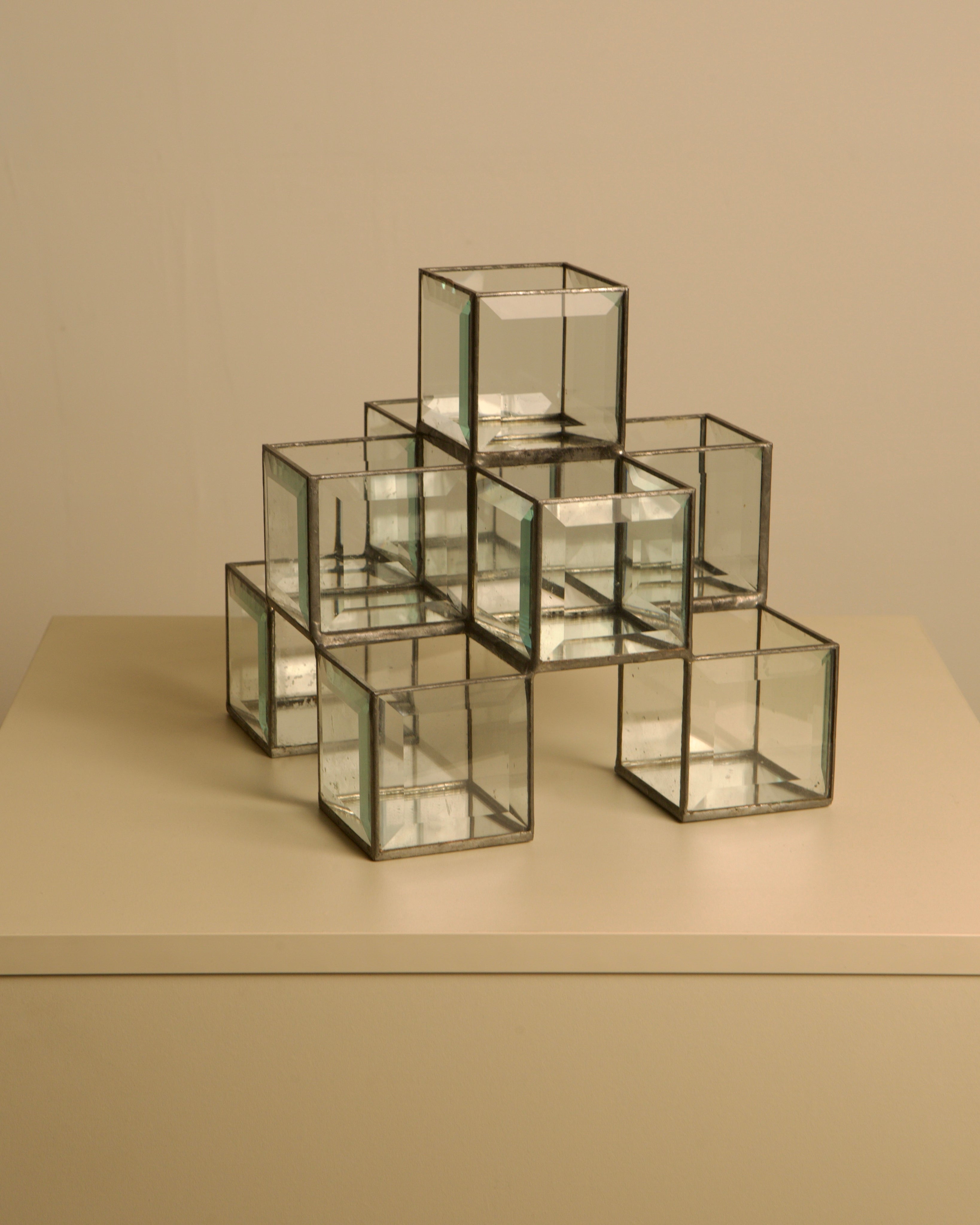 Italian handcrafted metal and glass candle holder from the 70s — close-up of glass cubes on neutral background