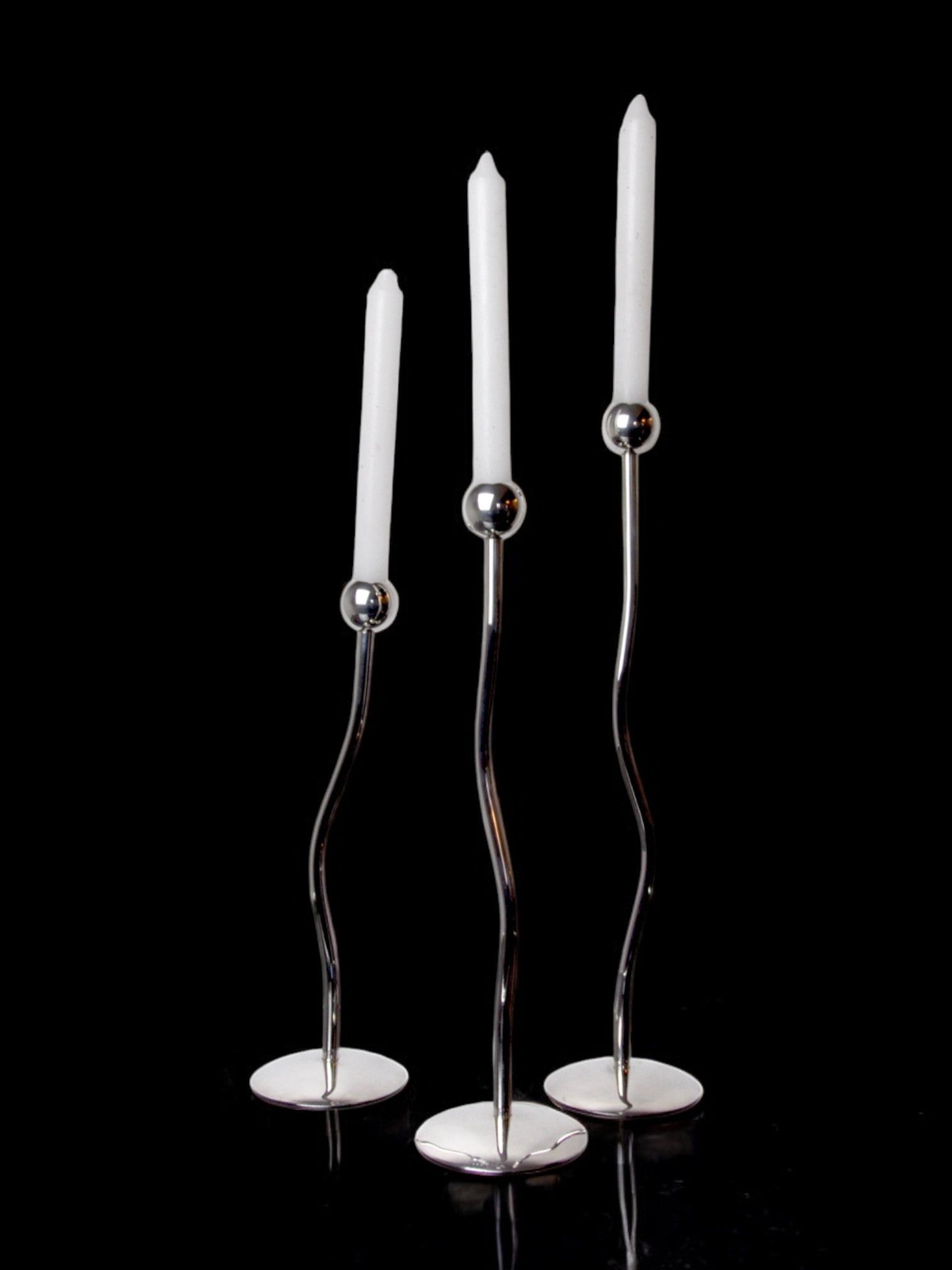 Trio of silver metal candlesticks from mesa italy, italy, 1980s — detail view