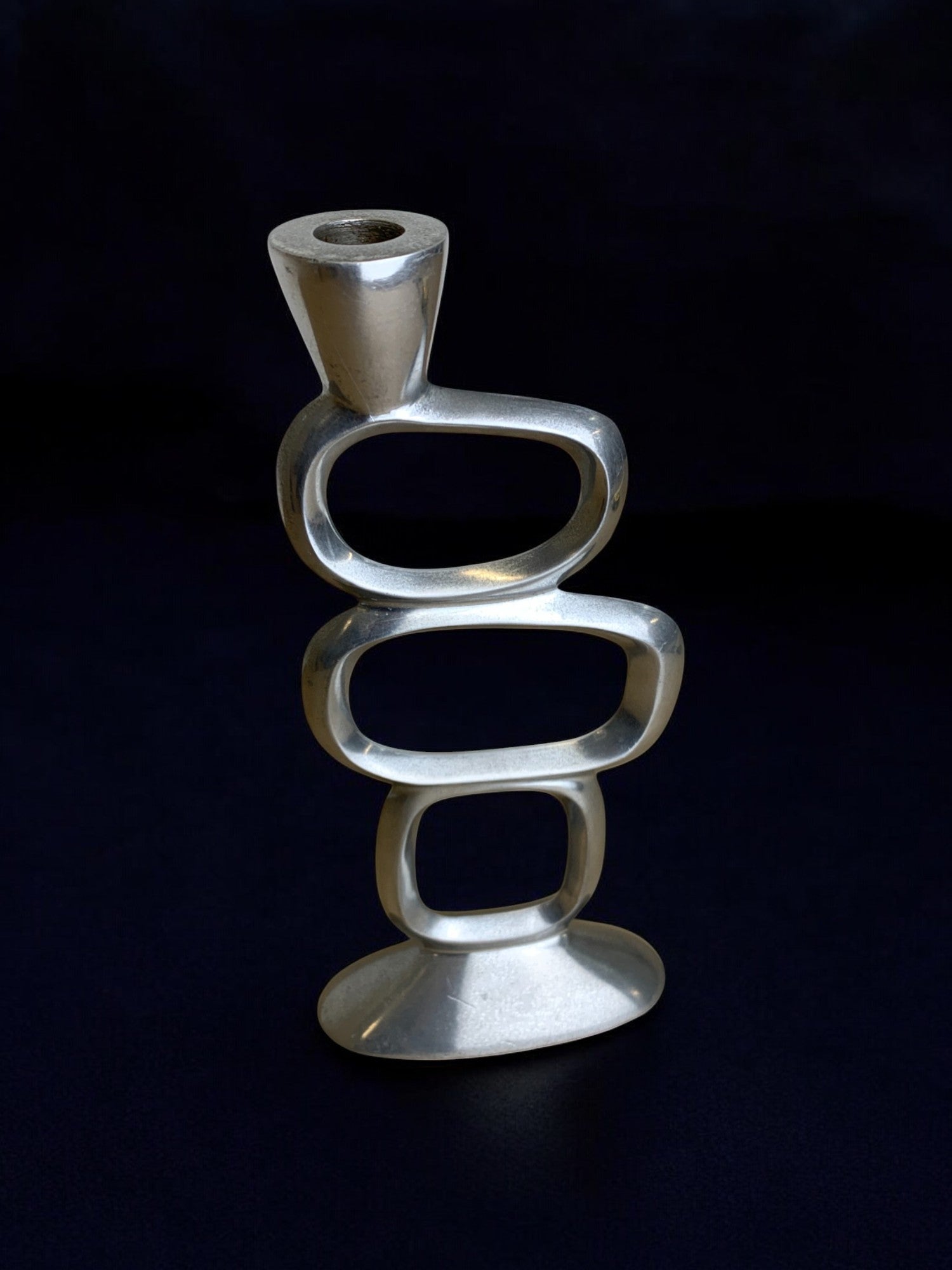 Circle Candleholder by Matthew Hilton, 1980's — angled view on dark background