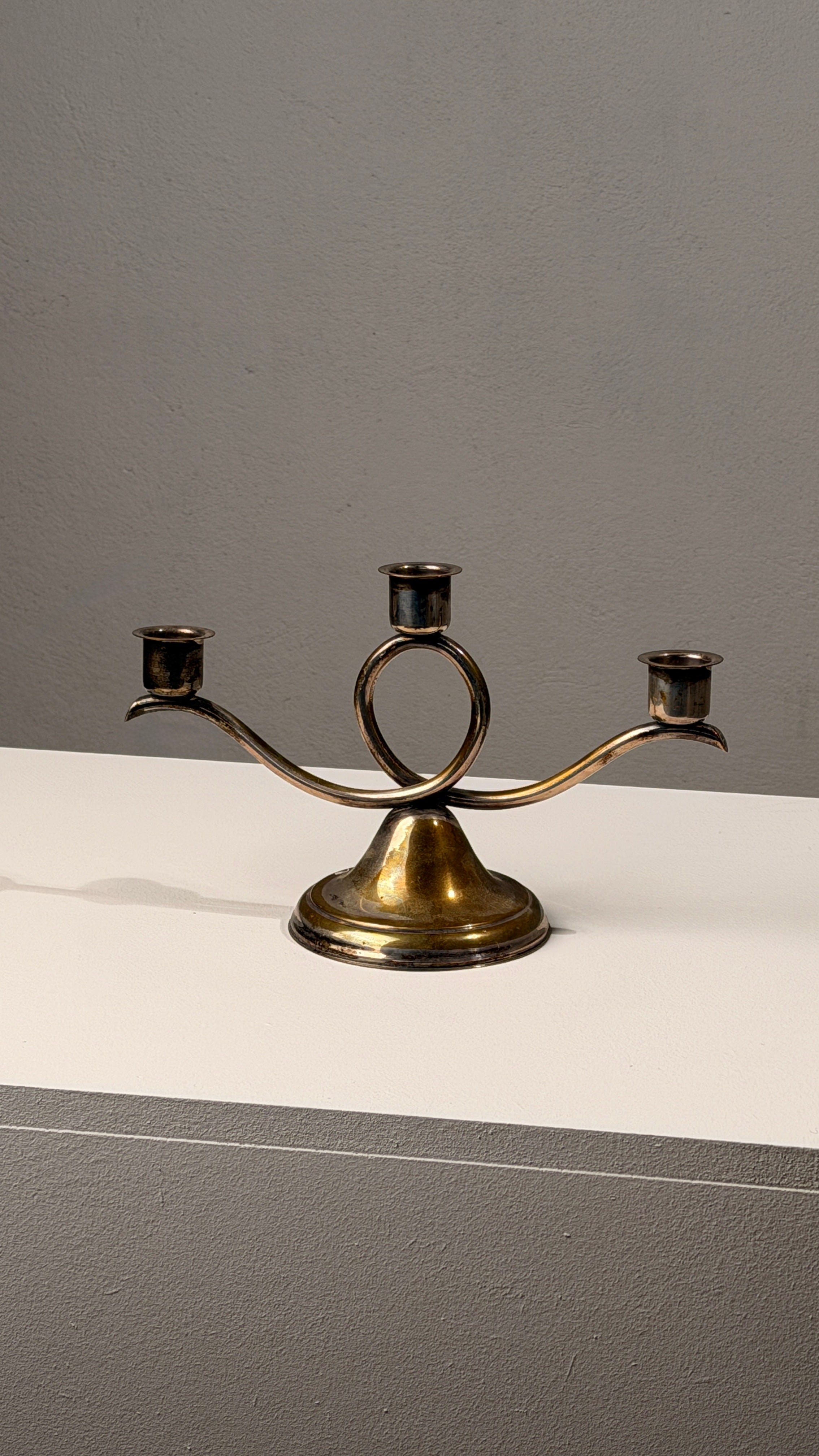 Silvered Metal Candelabra, France, 20th Century — angled view on light-colored surface