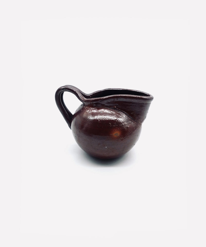 Dark brown vintage Italian terracotta pitcher with curved spout
