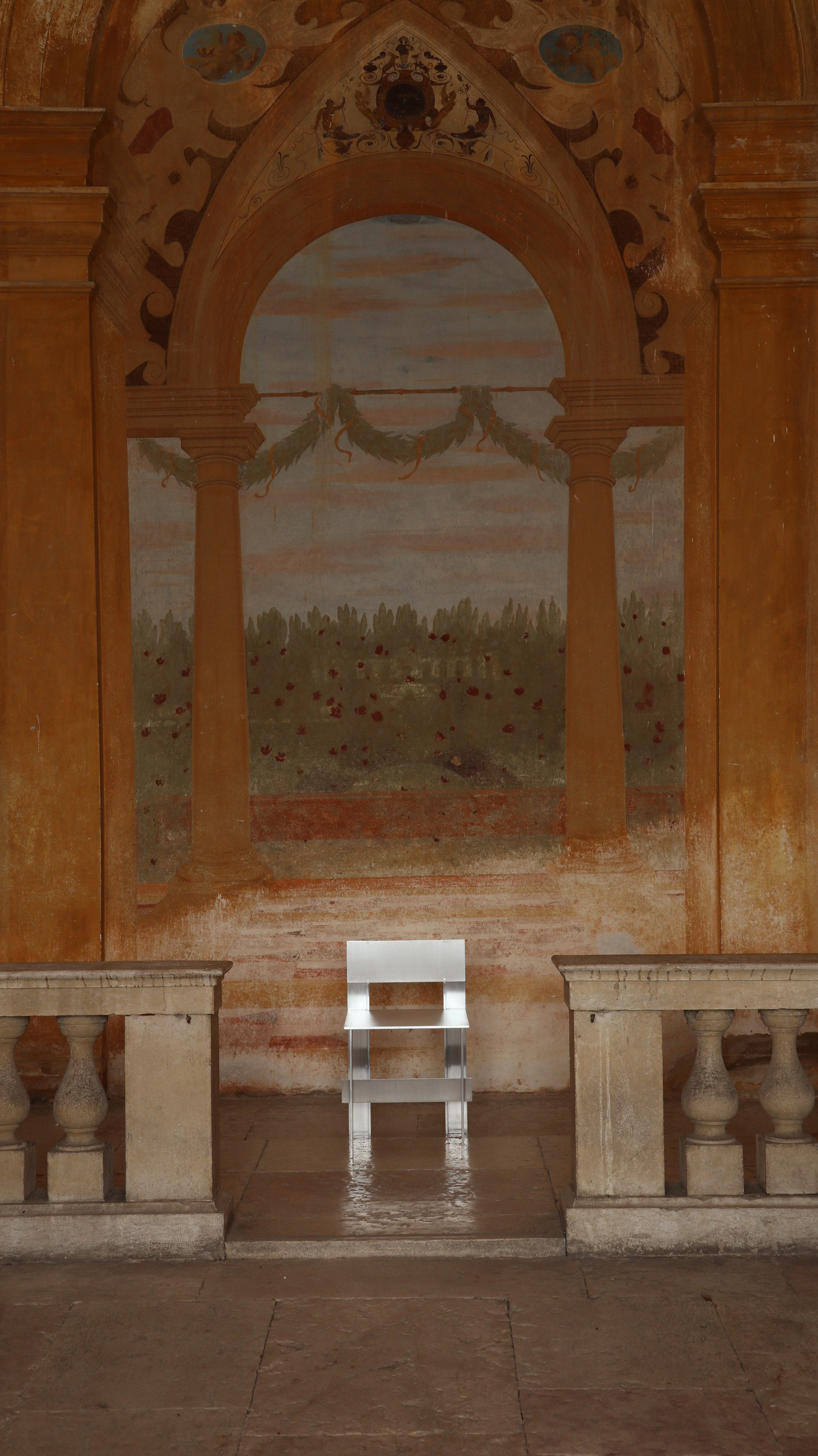 AL Chair — minimalist white chair in historic architectural setting