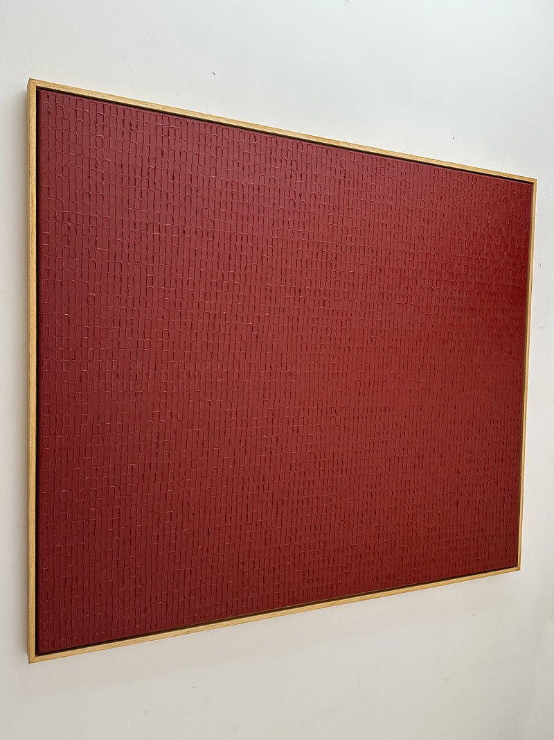 Textured red abstract painting with geometric pattern in gold frame