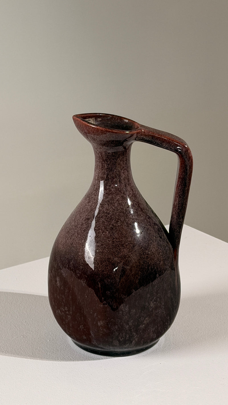 Ceramic pitcher by the Accolay potters, France, circa 1960 — close-up showing glossy dark red glaze