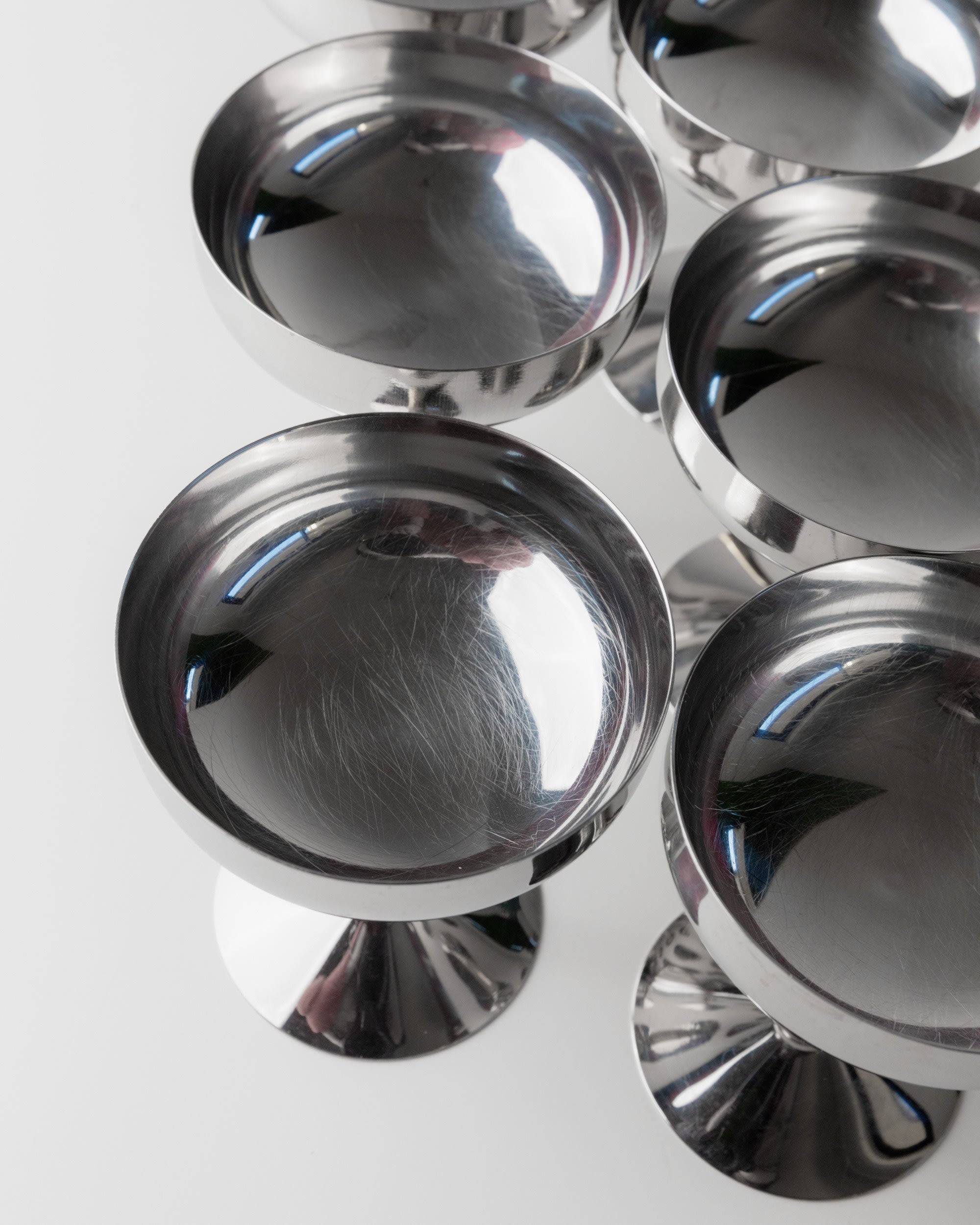 6 Stainless Steel Champagne Coupes 70s — overhead view on white background