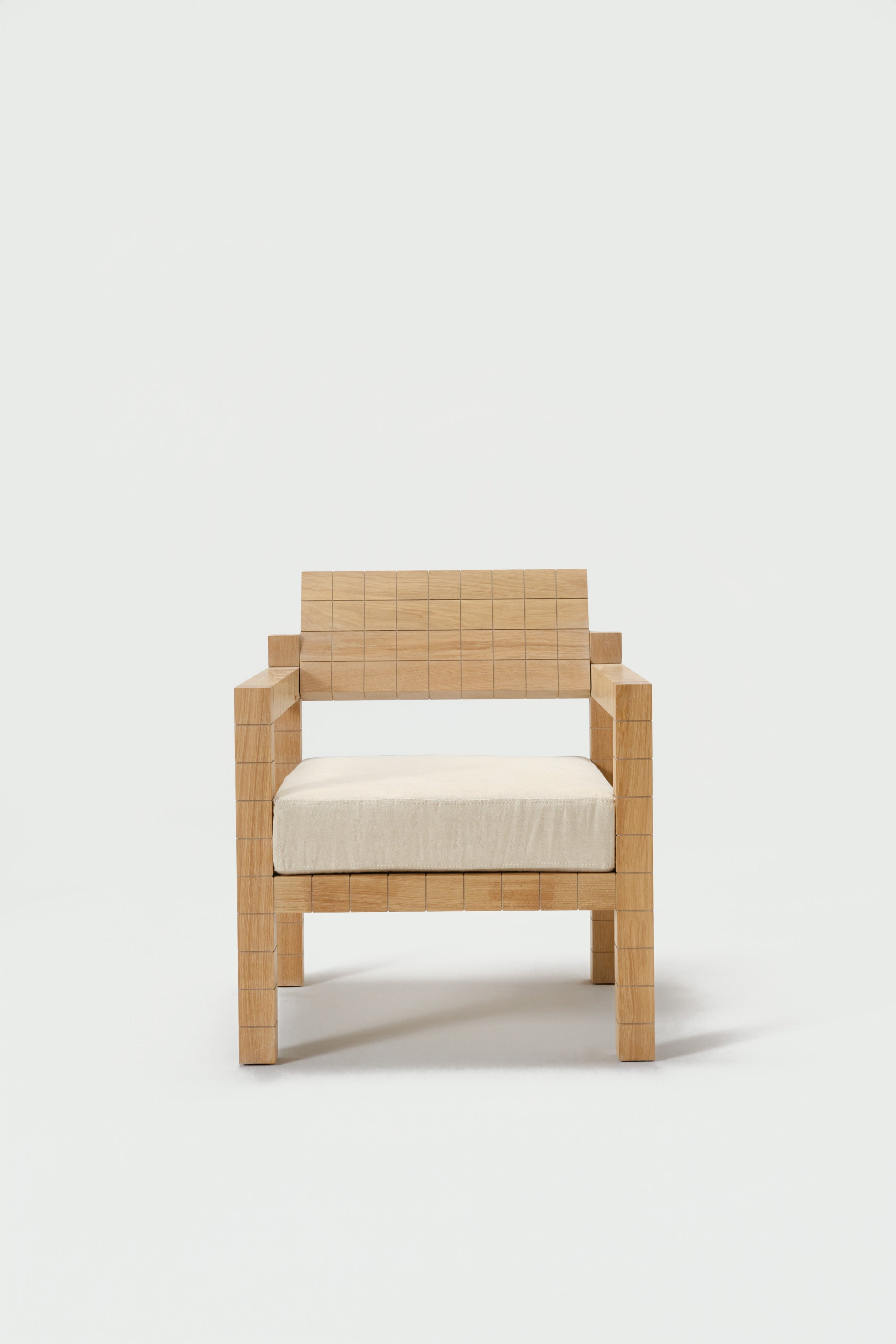 Mosaico Armchair — front view with natural wood finish and cream cushion