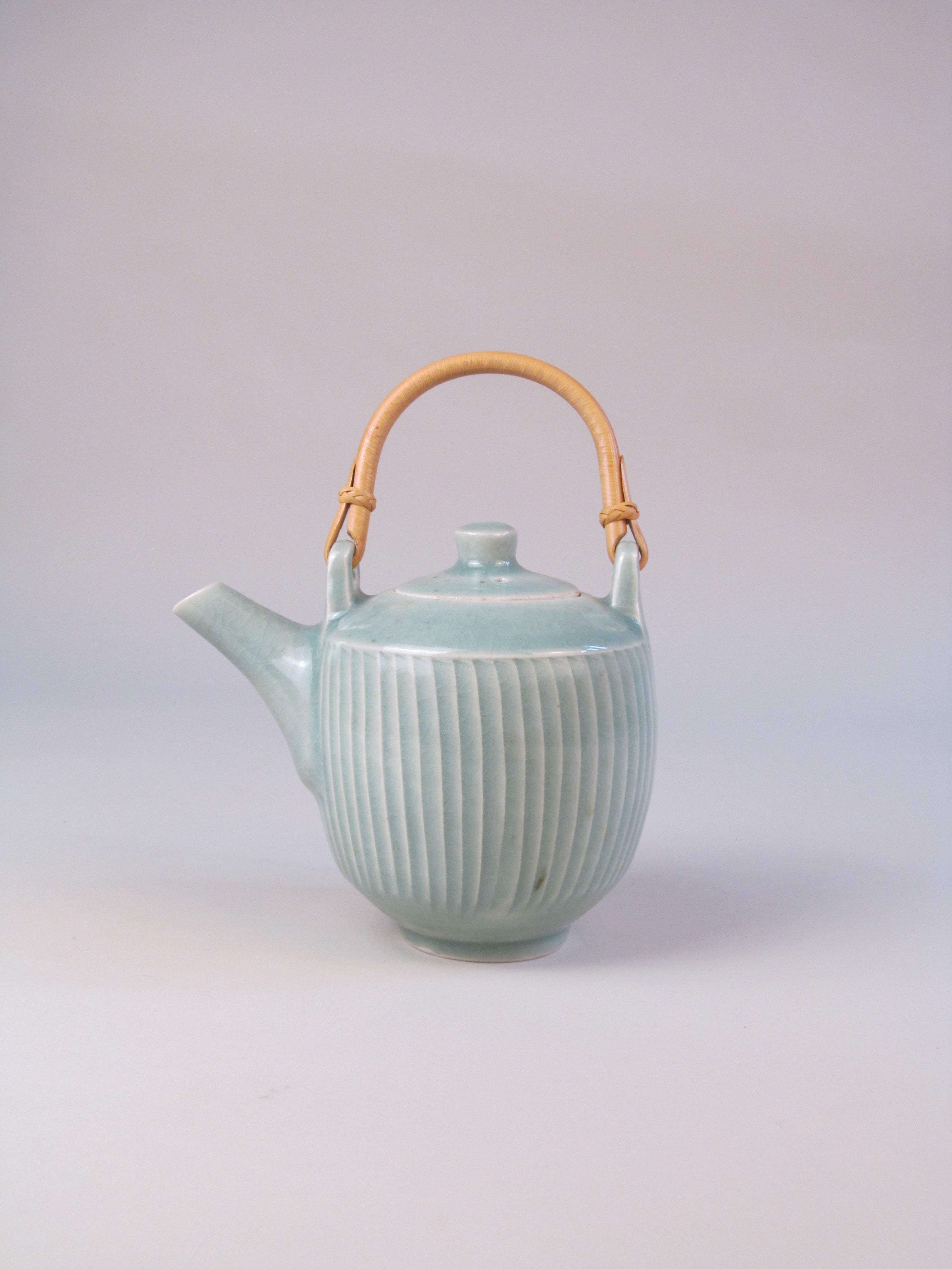 David Leach (1911-2005) Celadon Ribbed Teapot — close-up of ribbed celadon glaze with bamboo handle